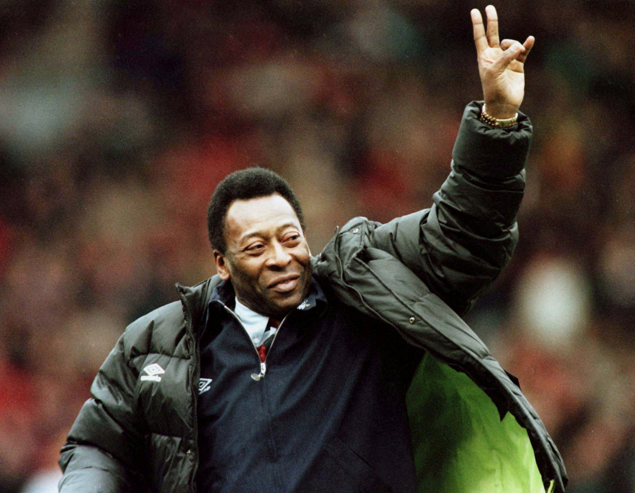 FILE PHOTO: Brazilian soccer legend Pele greets the crowd at the Manchester United versus Liverpool match during the half time interval in Manchester, Britain, April 10, 1998.  REUTERS