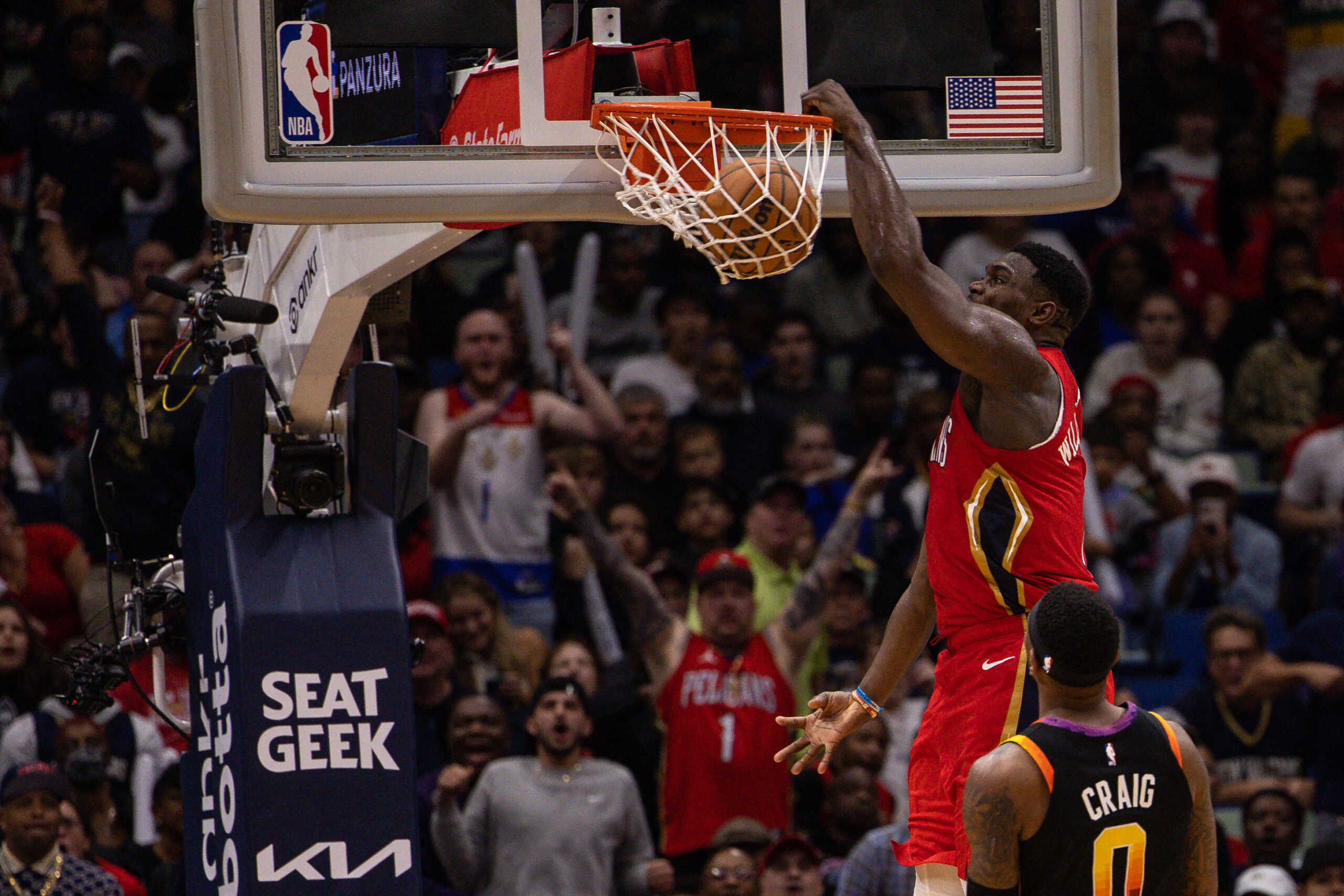 Dec 9, 2022; New Orleans, Louisiana, USA; New Orleans Pelicans forward Zion Williamson (1) dunks the ball against Phoenix Suns guard Devin Booker (1) and forward Torrey Craig (0) during the second half at Smoothie King Center. Mandatory Credit: Stephen Lew-USA TODAY Sports