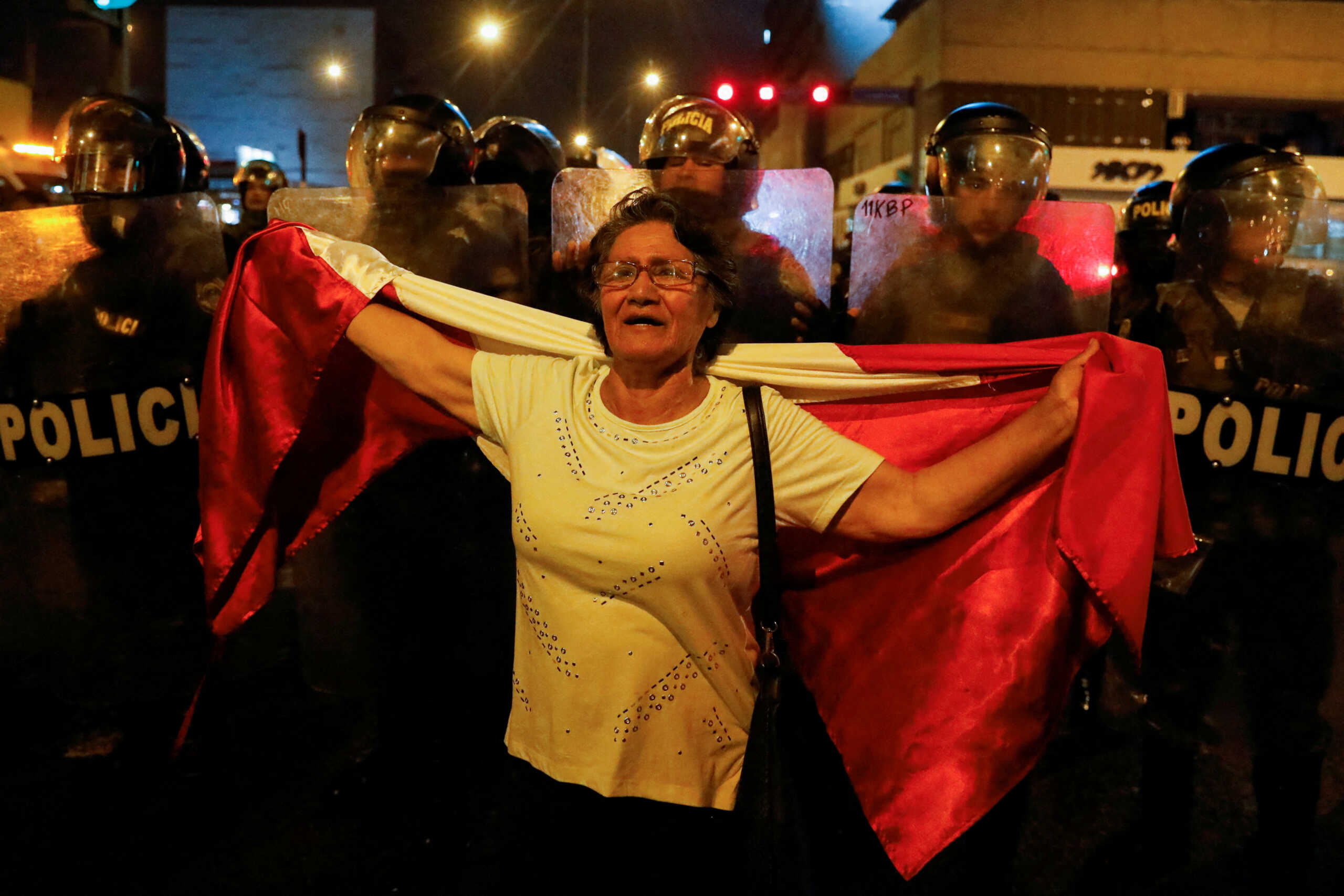 A demonstrator holds a flag during a protest that is continuing despite a government proposal to bring forward elections following the ouster of Peruvian leader Pedro Castillo, in Lima, Peru December 13, 2022. REUTERS