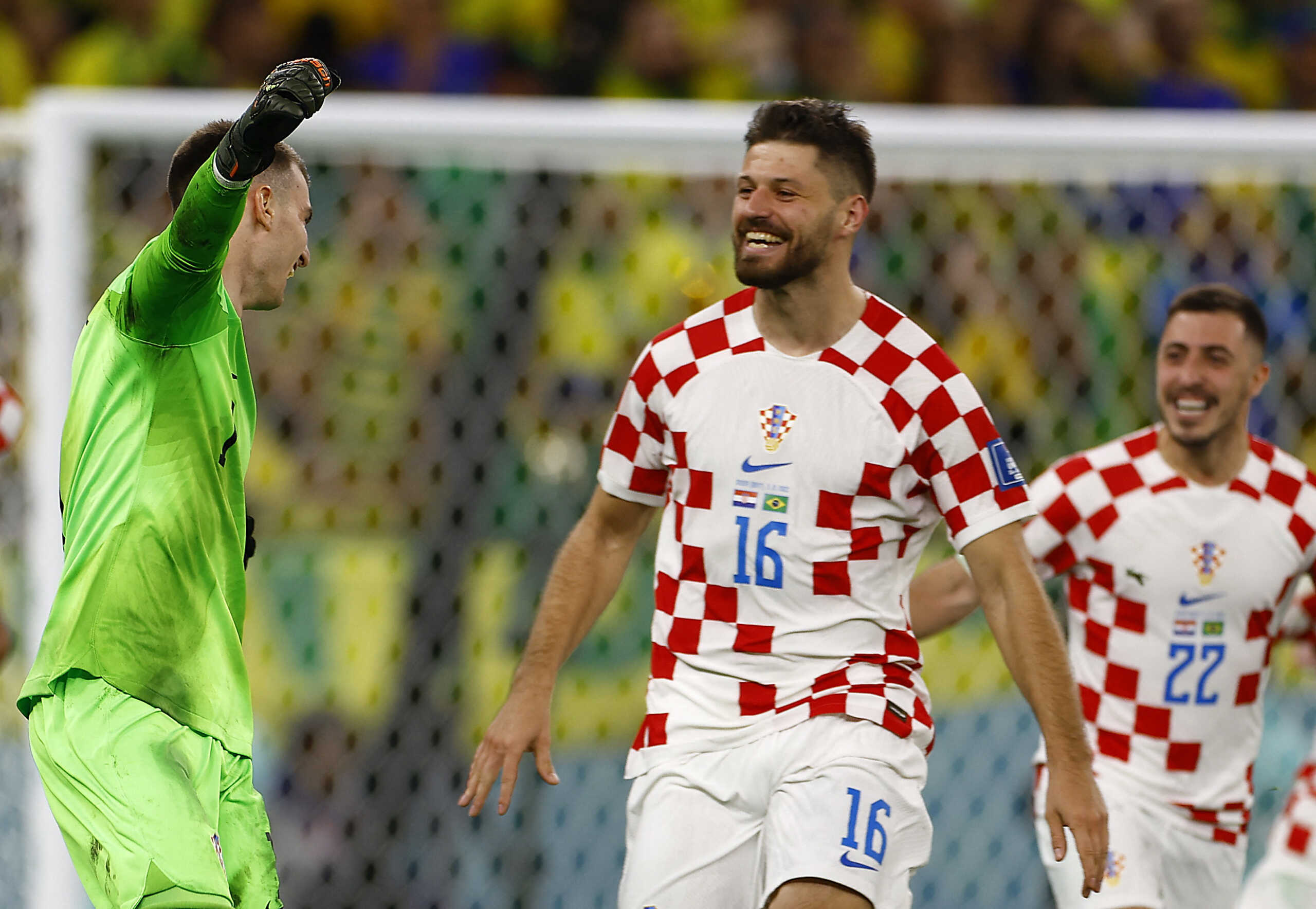 Soccer Football - FIFA World Cup Qatar 2022 - Quarter Final - Croatia v Brazil - Education City Stadium, Doha, Qatar - December 9, 2022 Croatia's Dominik Livakovic, Bruno Petkovic and Josip Stanisic celebrate qualifying for the semi finals REUTERS