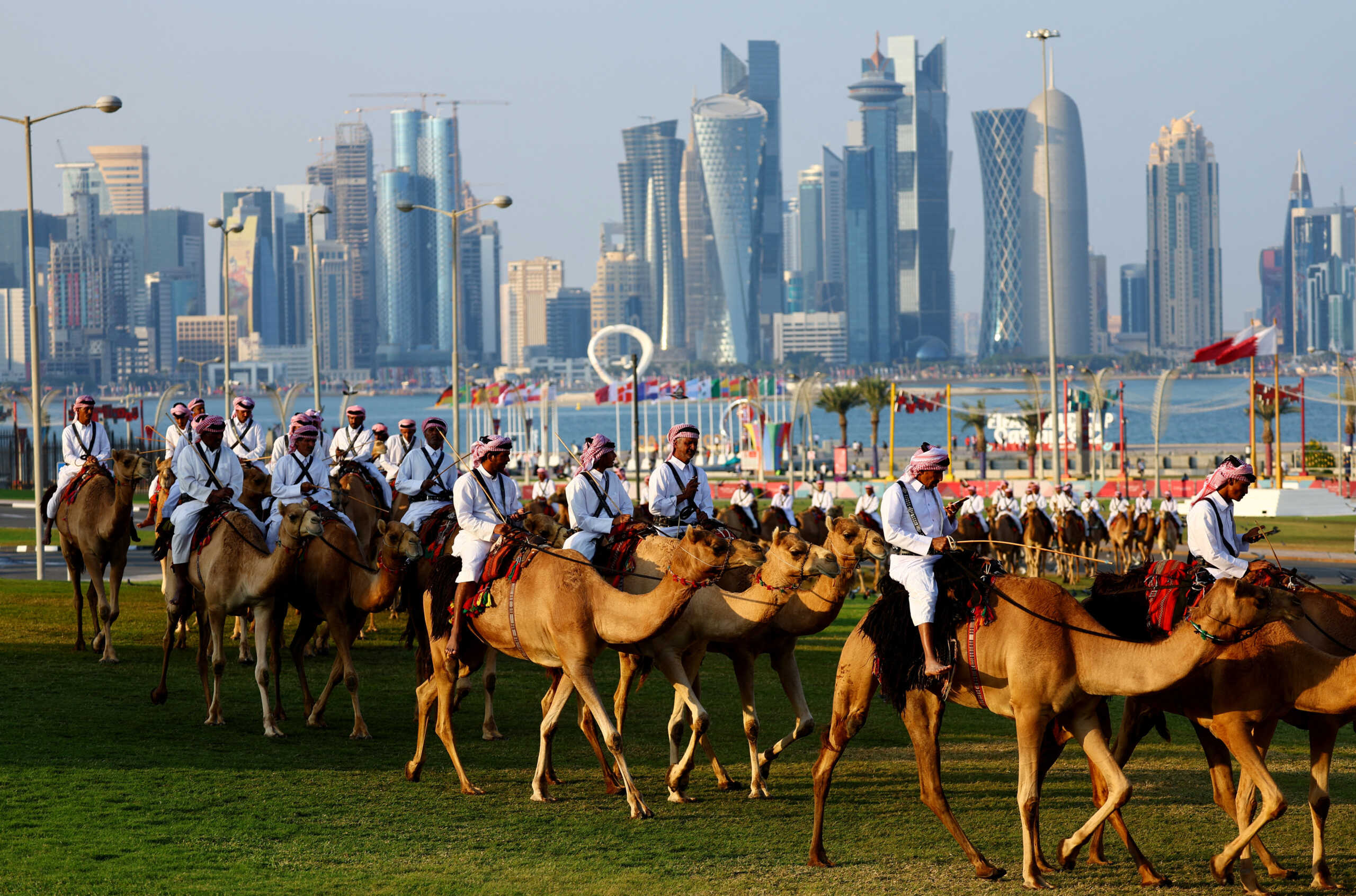 Soccer Football - FIFA World Cup Qatar 2022 - Doha, Qatar - December 13, 2022 People ride Dromedaries in Doha REUTERS