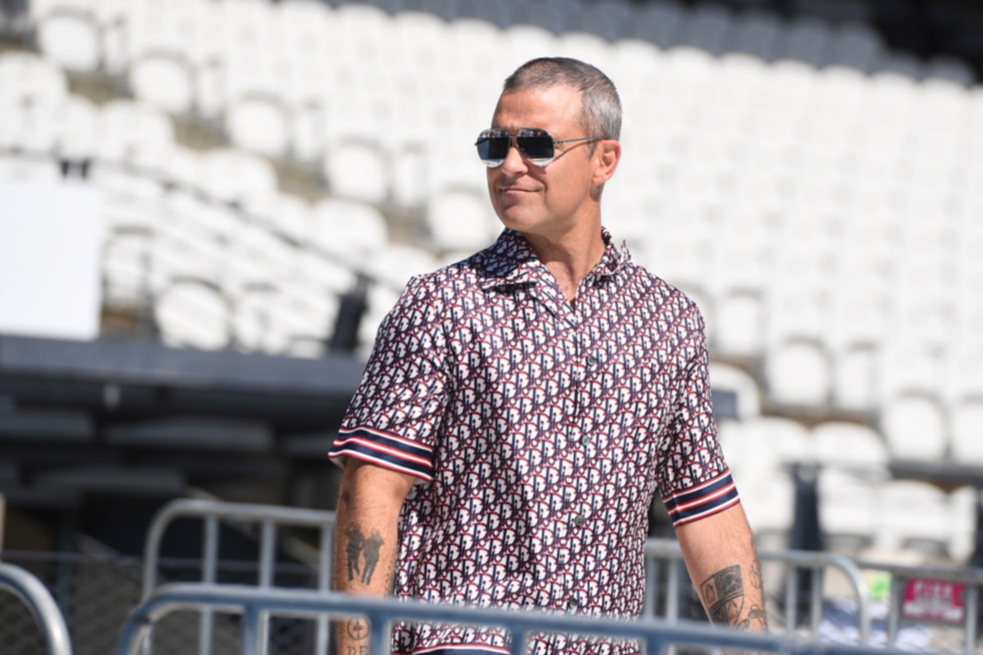 epa08287974 British singer Robbie Williams arrives to speak to the media ahead of his performance at World Tour Melbourne, during a media opp at Lakeside Stadium in Melbourne, Australia. 12 March 2020. Williams will perform in Melbourne on 14 March 2020.  EPA