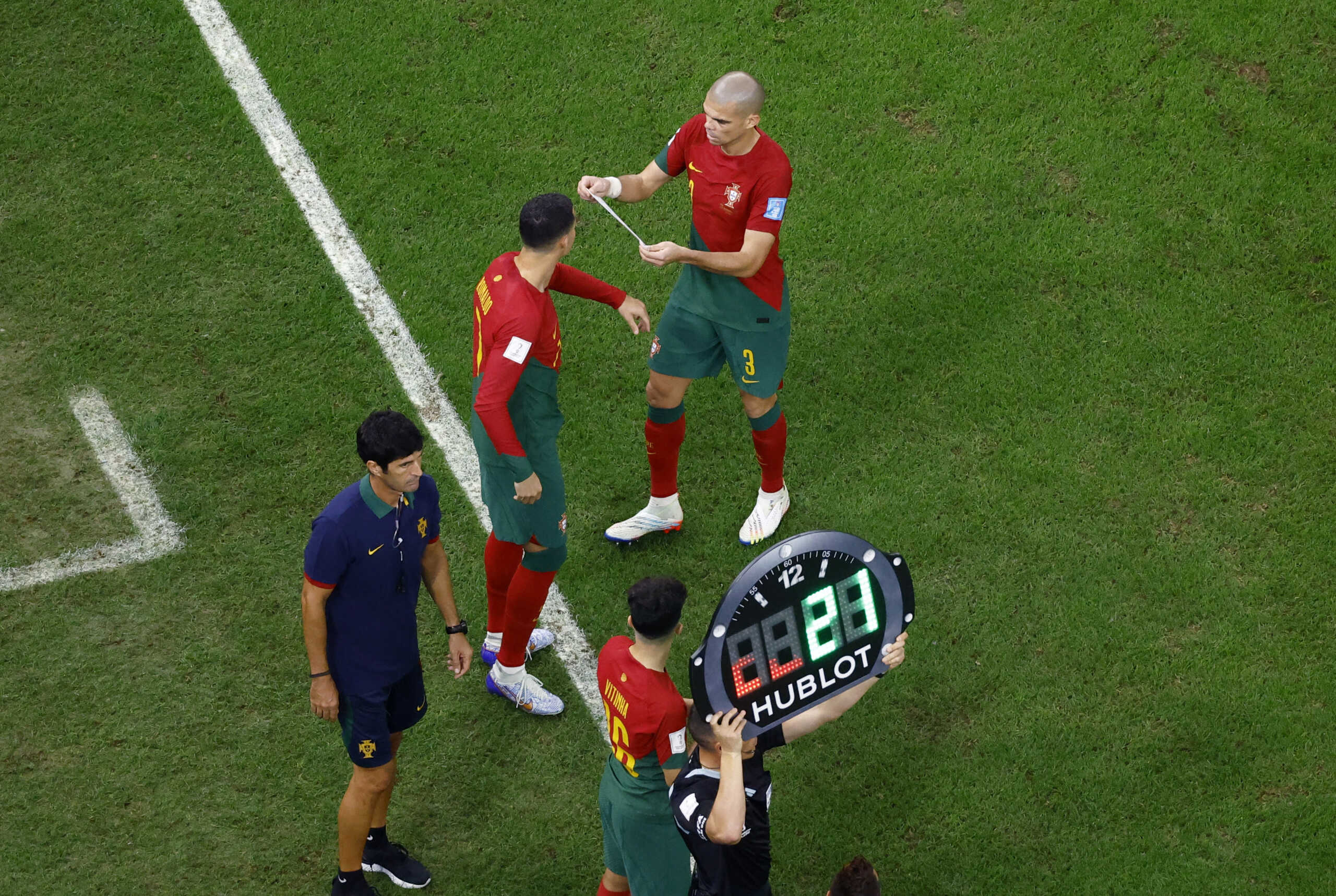 Soccer Football - FIFA World Cup Qatar 2022 - Round of 16 - Portugal v Switzerland - Lusail Stadium, Lusail, Qatar - December 6, 2022 Portugal's Cristiano Ronaldo is given the captain's armband by teammate Pepe as he comes on as a substitute REUTERS