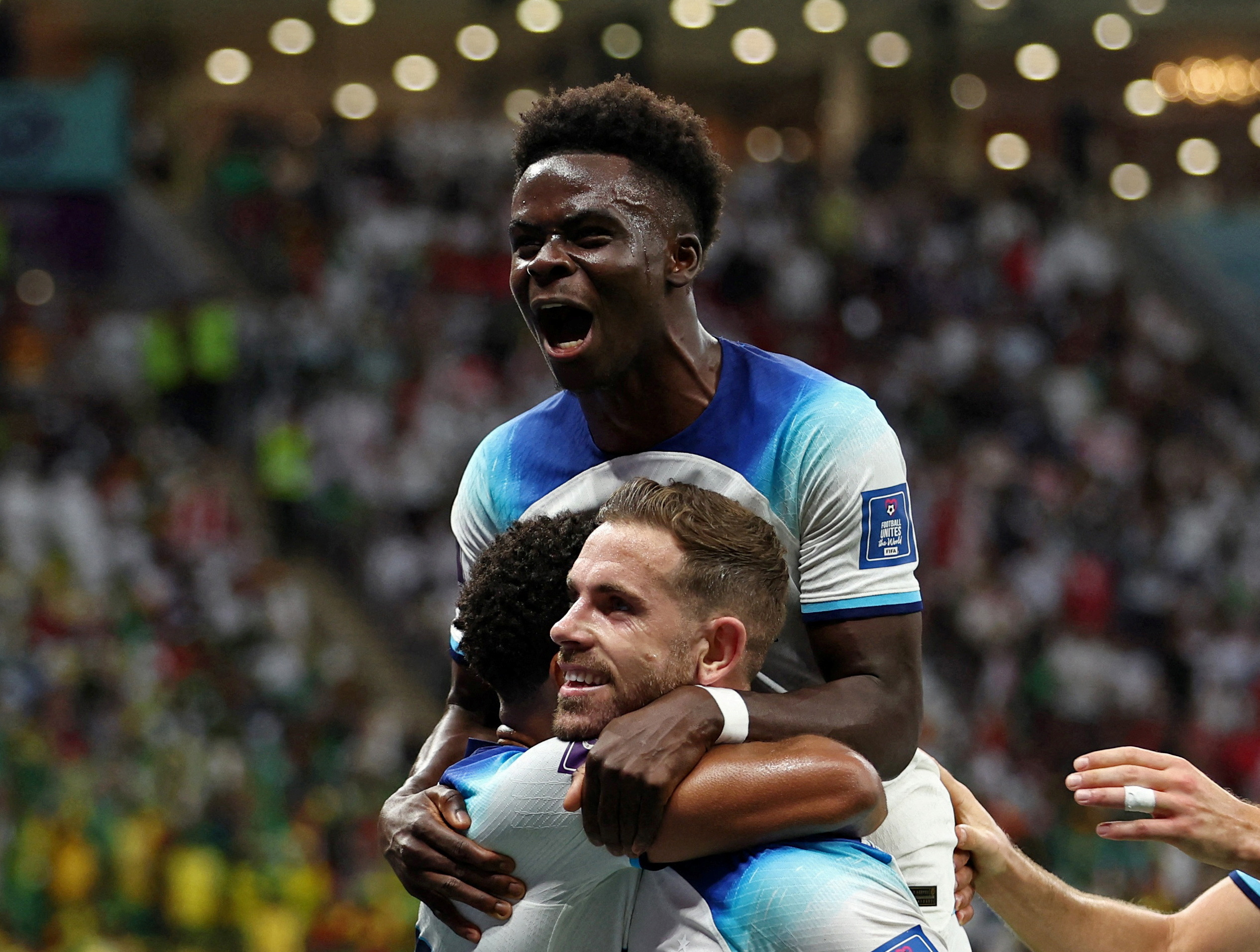 Soccer Football - FIFA World Cup Qatar 2022 - Round of 16 - England v Senegal - Al Bayt Stadium, Al Khor, Qatar - December 4, 2022 England's Jordan Henderson celebrates scoring their first goal with Bukayo Saka REUTERS
