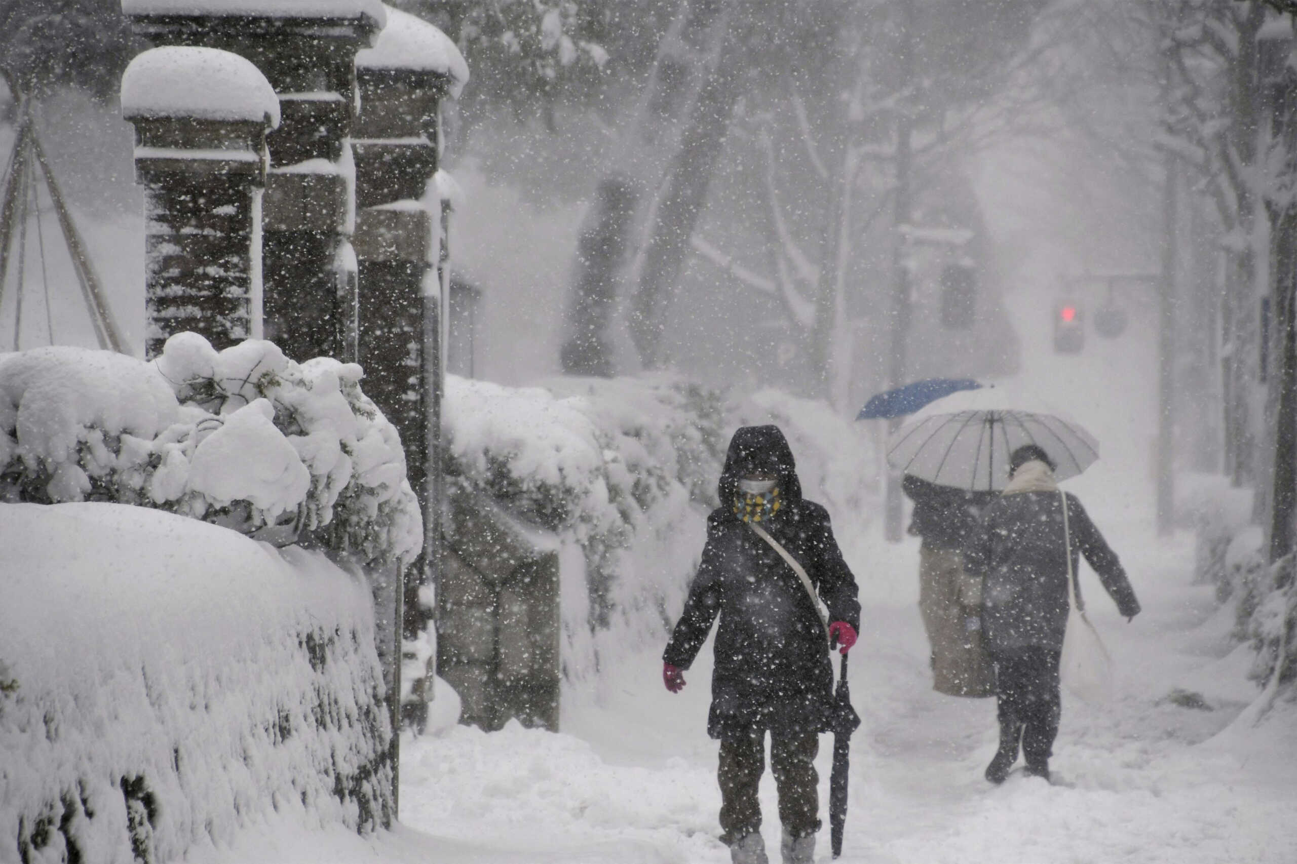 People make their way in the heavy snow in Kanazawa, Ishikawa Prefecture, central Japan in this photo taken by Kyodo on December 23, 2022.  Mandatory credit Kyodo