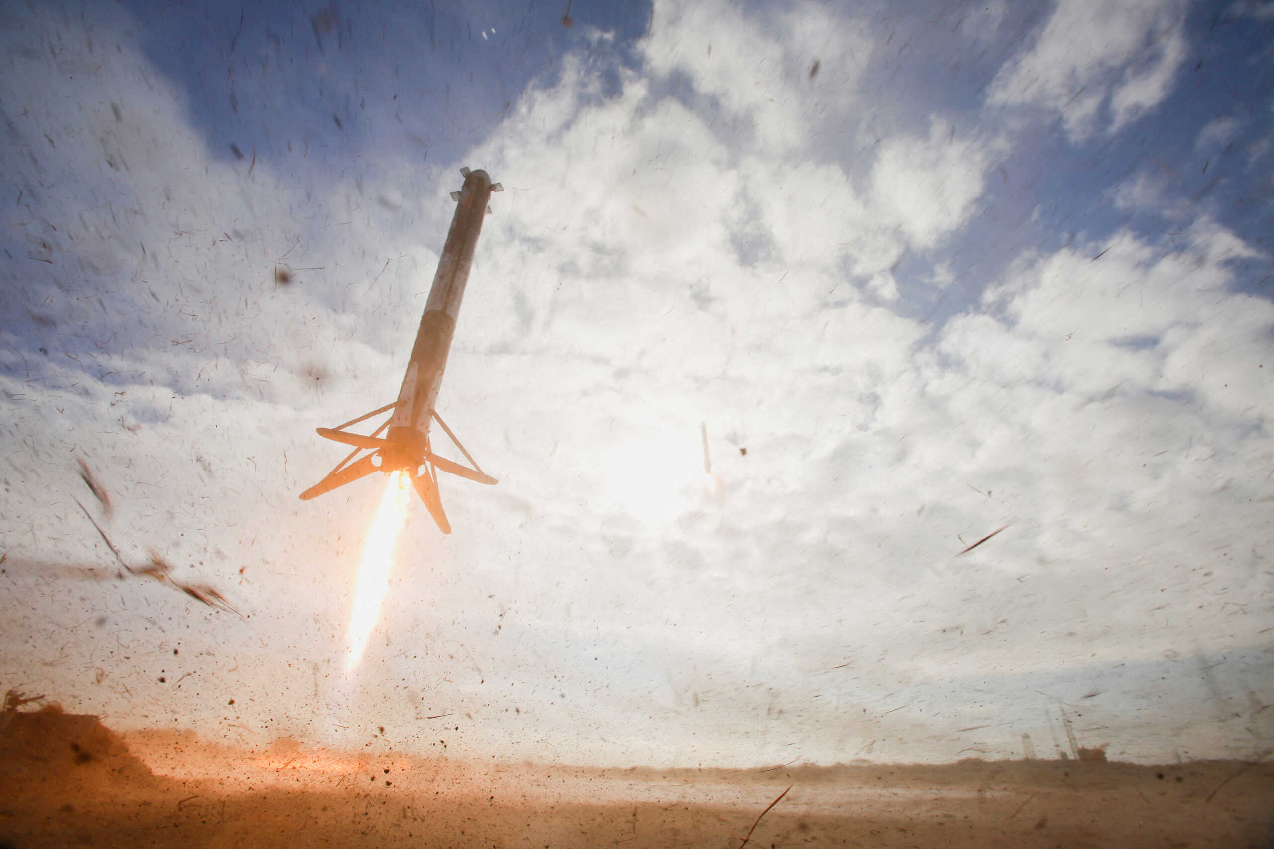 FILE PHOTO: A SpaceX Falcon Heavy rocket booster descends to landing after launch with a classified payload for the U.S. Space Force at Cape Canaveral, Florida, U.S., November 1, 2022. REUTERS