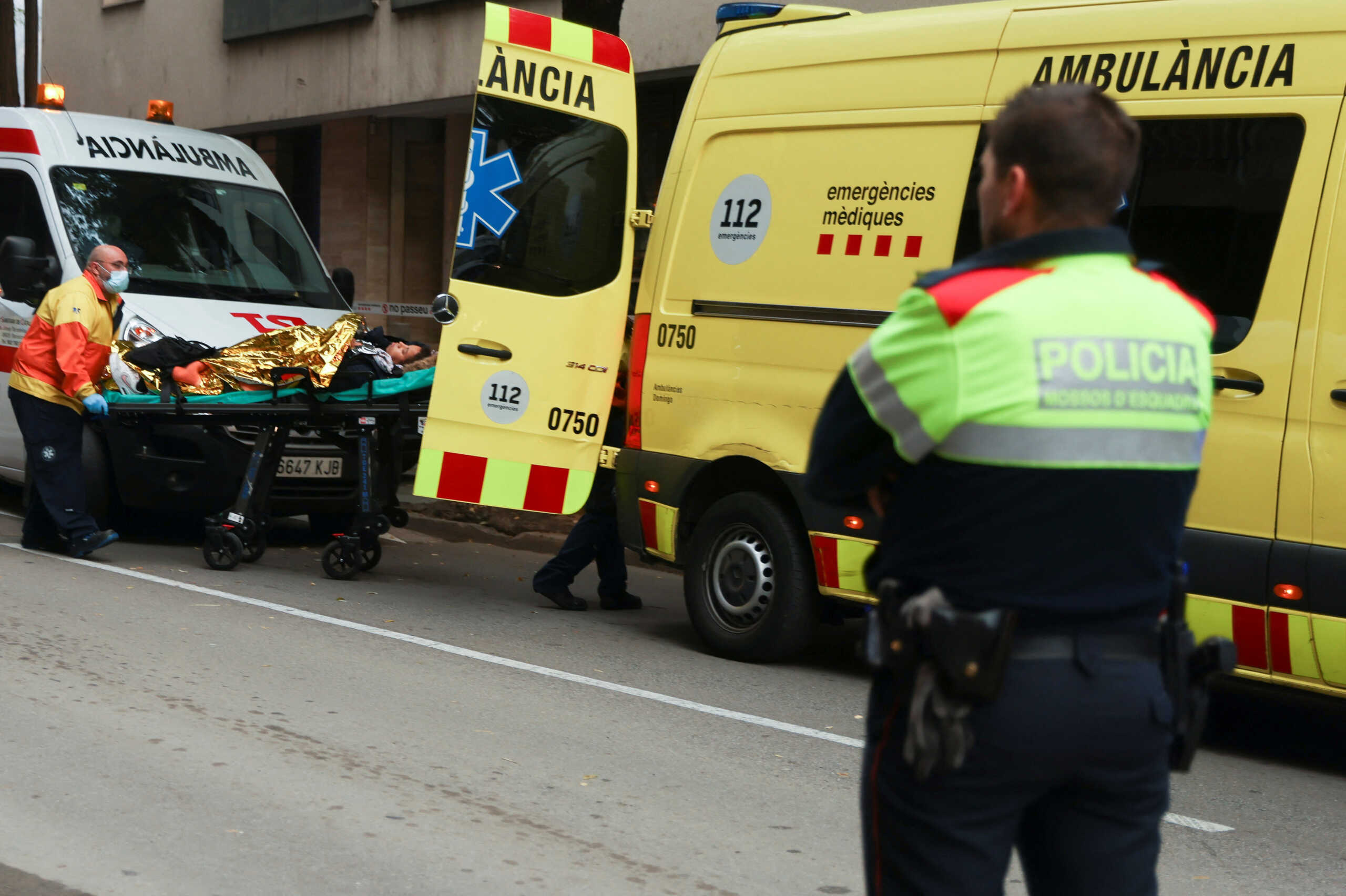 A wounded person is helped by medical emergency after two trains collided in Spain's northeastern Catalonia region, in Montcada i Reixac, near Barcelona, Spain December 7, 2022. REUTERS