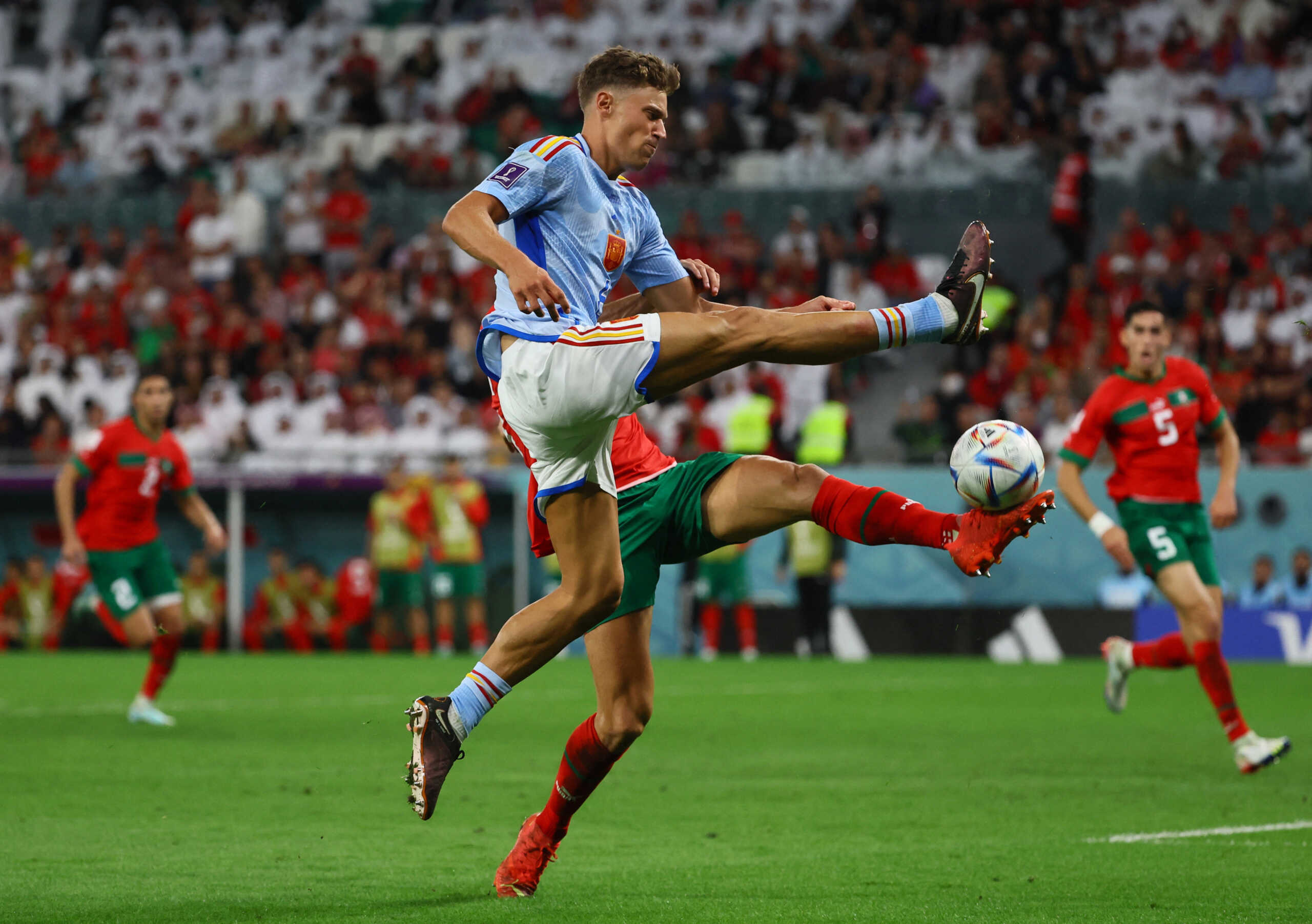 Soccer Football - FIFA World Cup Qatar 2022 - Round of 16 - Morocco v Spain - Education City Stadium, Al Rayyan, Qatar - December 6, 2022 Spain's Marcos Llorente in action with Morocco's Romain Saiss REUTERS