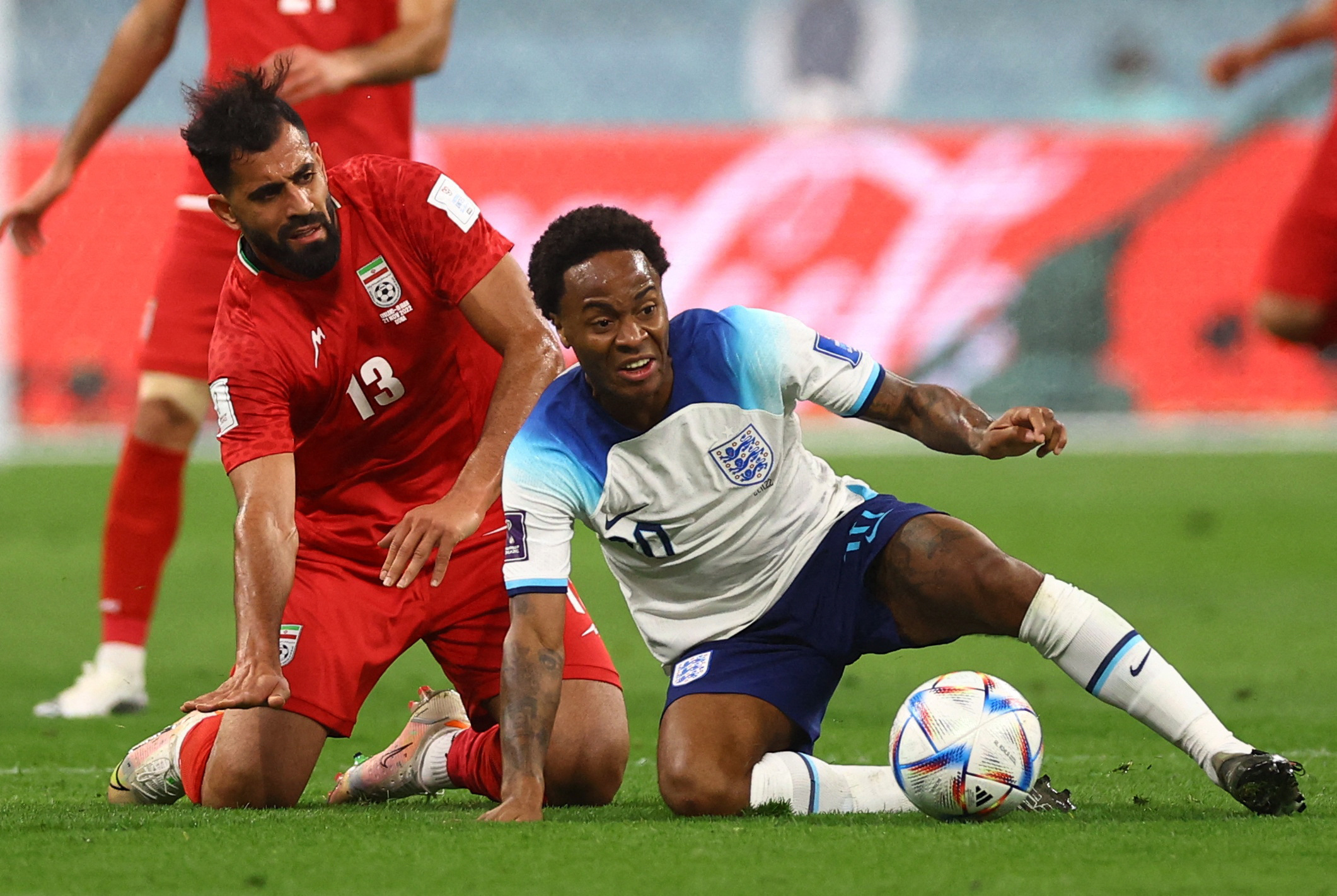 Soccer Football - FIFA World Cup Qatar 2022 - Group B - England v Iran - Khalifa International Stadium, Doha, Qatar - November 21, 2022 England's Raheem Sterling in action with Iran's Hossein Kanani REUTERS