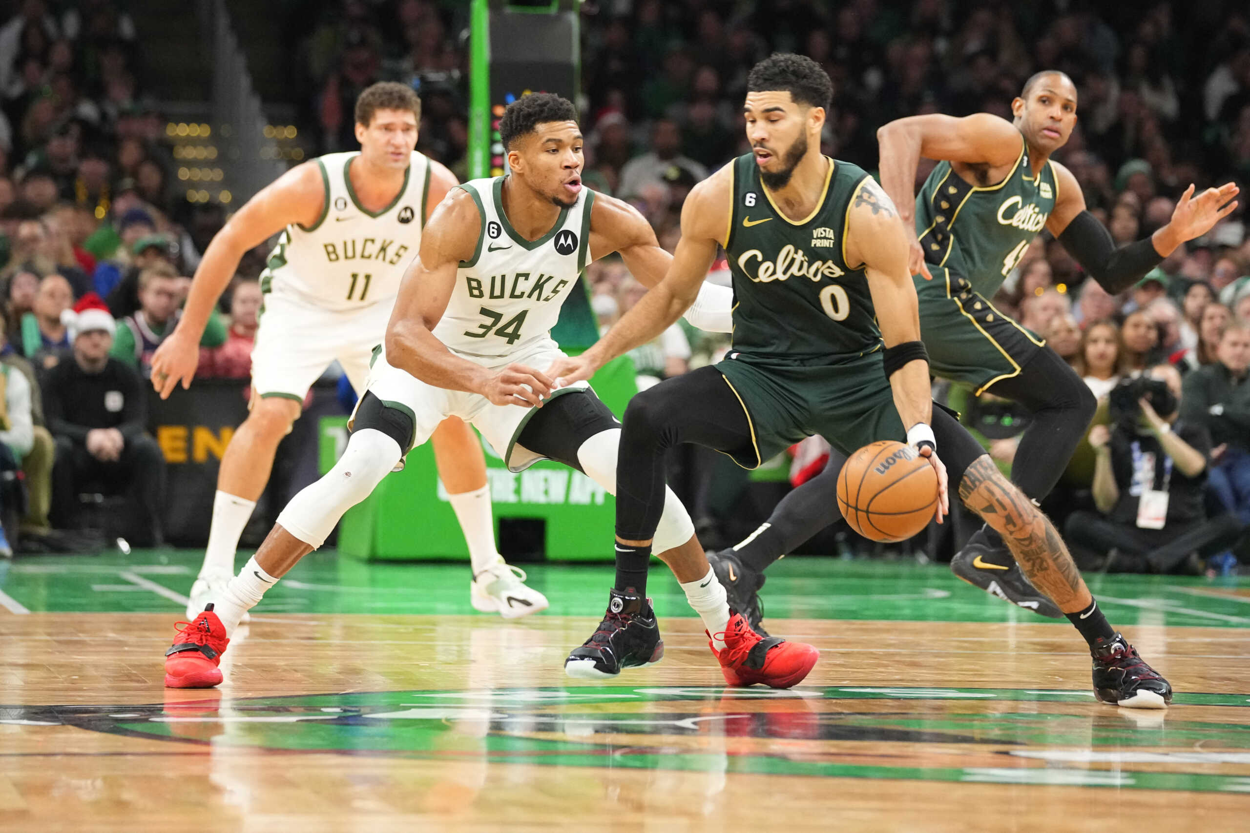 Dec 25, 2022; Boston, Massachusetts, USA; Boston Celtics small forward Jayson Tatum (0) dribbles the ball against Milwaukee Bucks power forward Giannis Antetokounmpo (34) during the second half at TD Garden. Mandatory Credit: Gregory Fisher-USA TODAY Sports