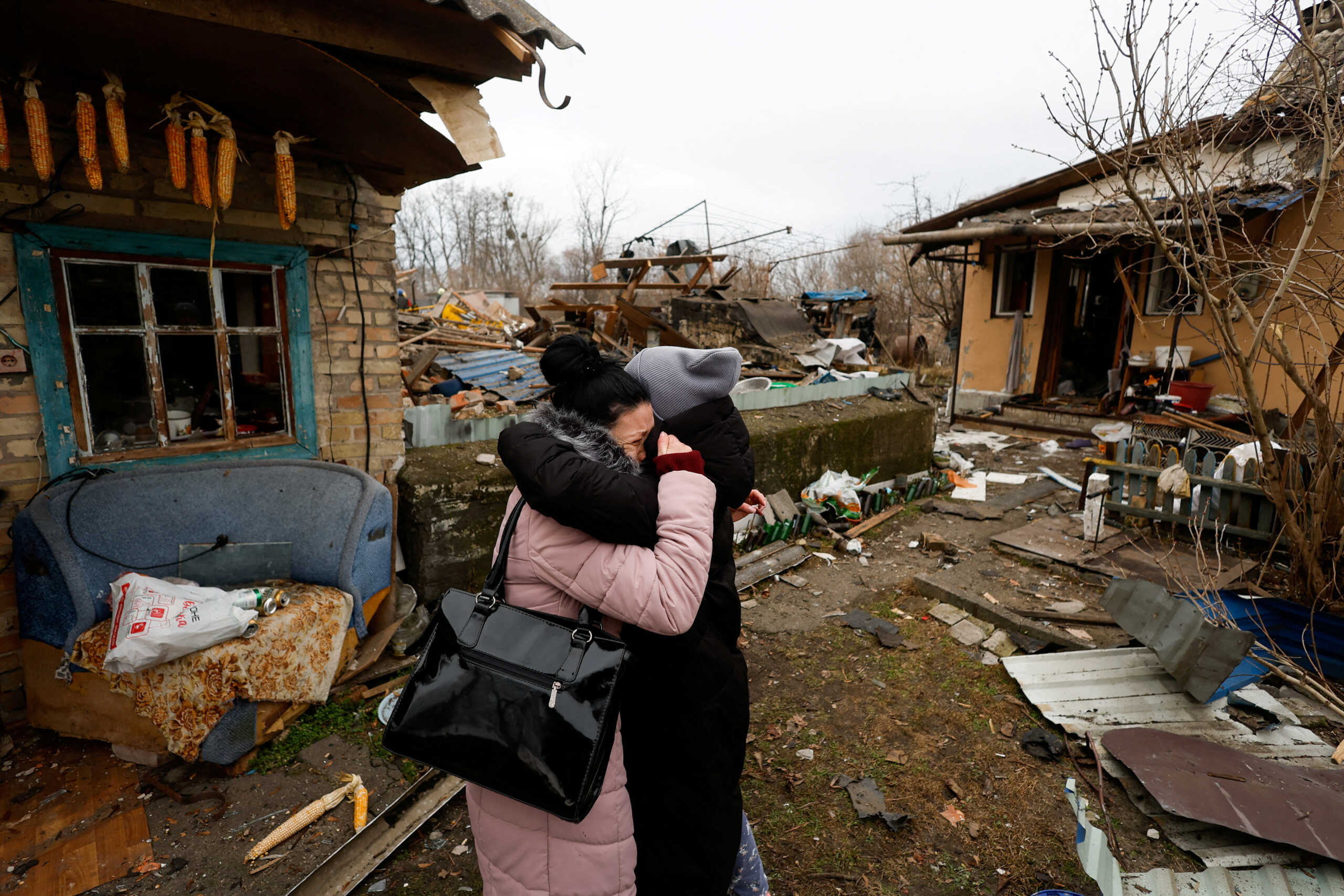 A local resident Yana embraces a friend as she reacts next to her mother's house damaged during a Russian missile strike, amid Russia's attack on Ukraine, in Kyiv, Ukraine December 29, 2022. REUTERS