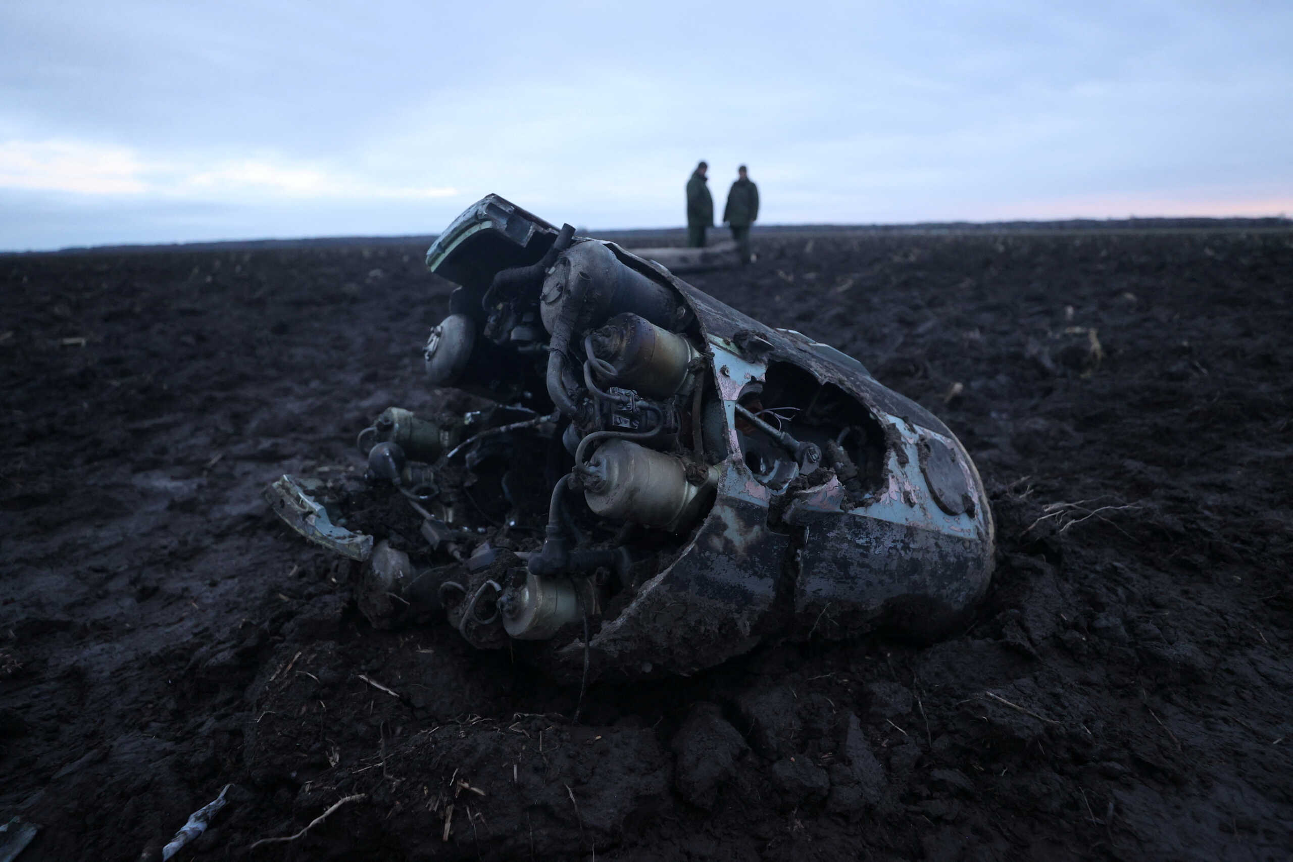 Investigators gather near fragments of a munition, what Belarus' defence ministry said were parts of a Ukrainian S-300 missile downed by Belarusian air defences outside the village of Harbacha in the Grodno region, Belarus, December 29, 2022. Vadzim Yakubionak