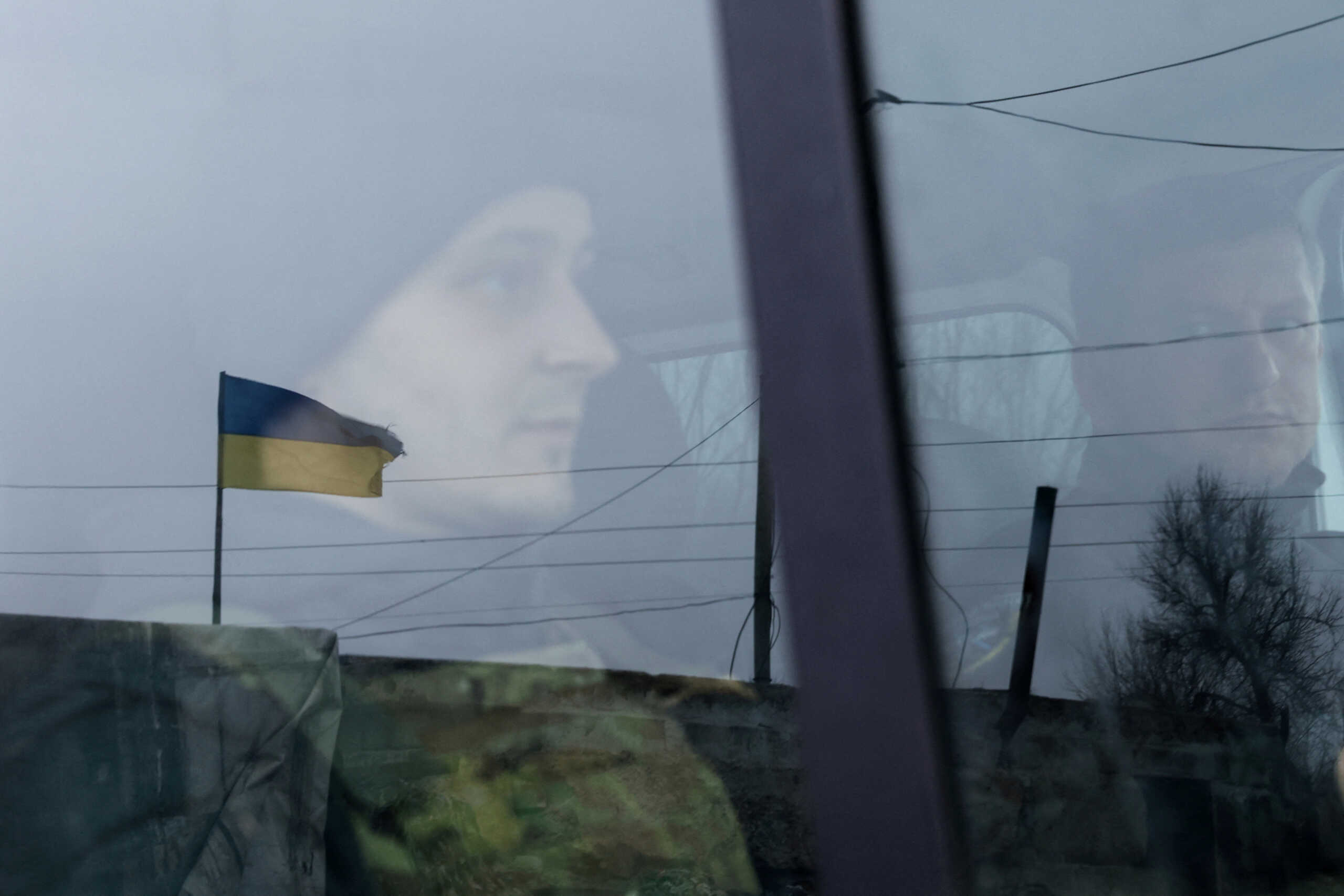 Members of the volunteer organisation Chaplain Patrol drive Valentyna, 70, to the Pokrovsk train station after she was evacuated from Bakhmut, en route to meet her son in Kyiv, Ukraine, December 13, 2022. REUTERS