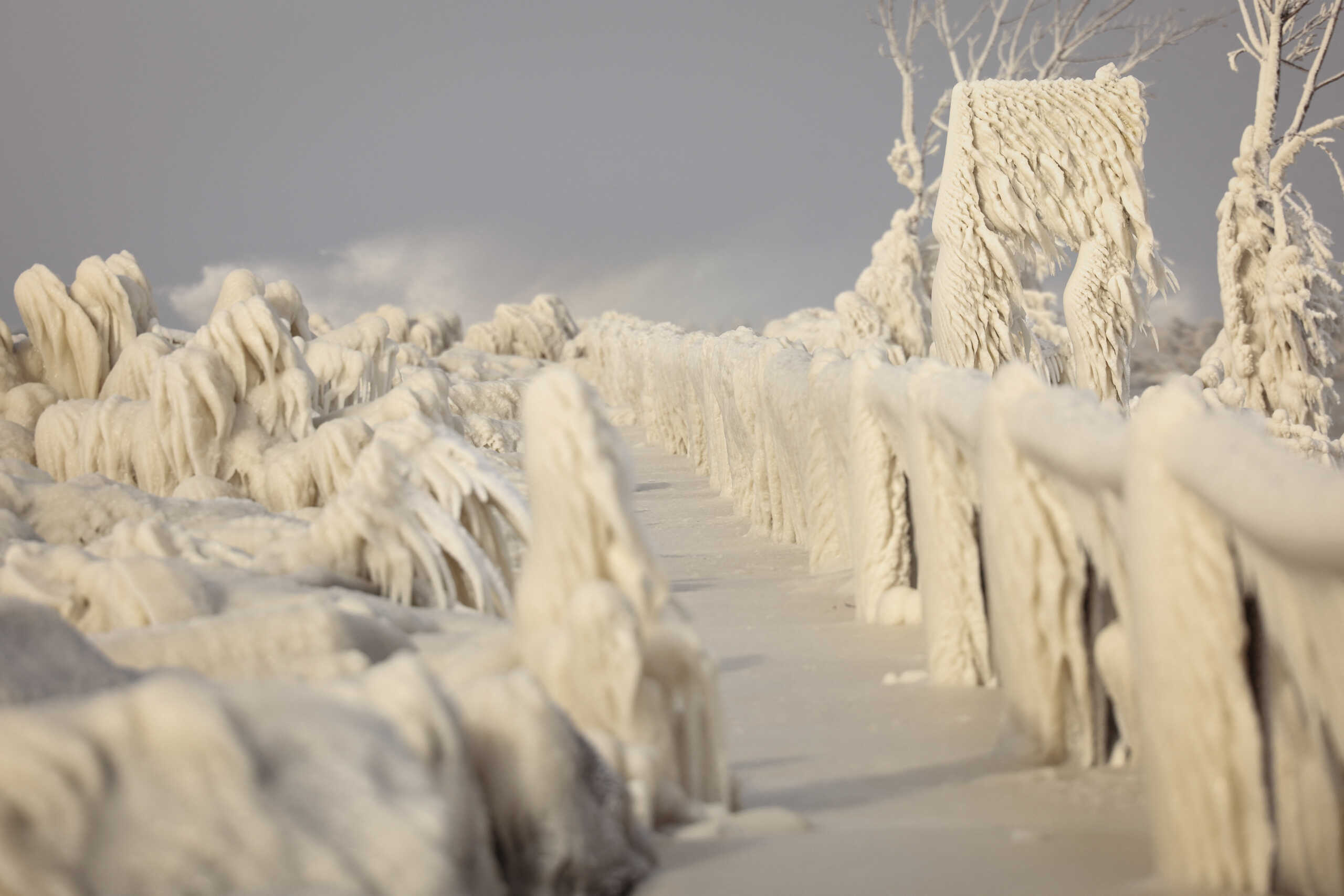Ice formed by the spray of Lake Erie waves covers a walkway during a winter storm in Irving, New York, U.S., December 24, 2022.  REUTERS
