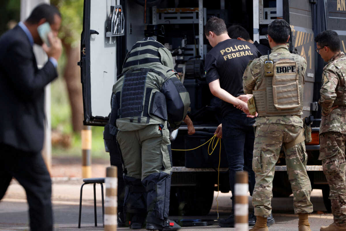 Security forces work as a robot of the federal police bomb squad is seen near what is believed to be an explosive artifact in Brasilia, Brazil, December 24, 2022. REUTERS