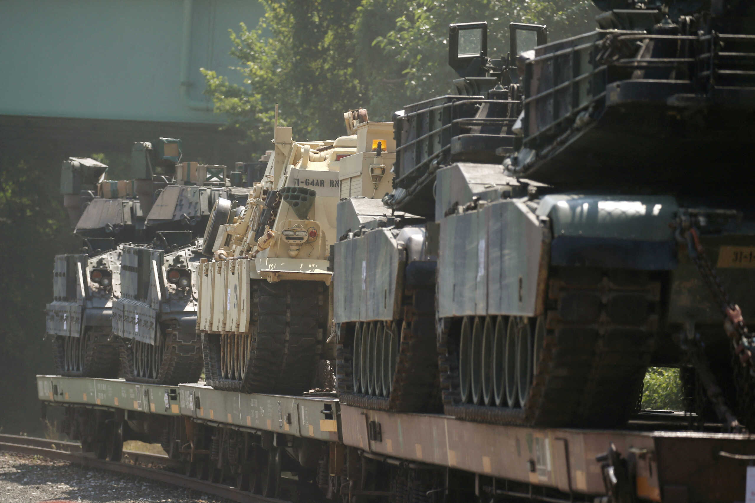 FILE PHOTO: M1 Abrams tanks and other armored vehicles sit atop flat cars in a rail yard after U.S. President Donald Trump said tanks and other military hardware would be part of Fourth of July displays of military prowess in Washington, U.S., July 2, 2019. REUTERS