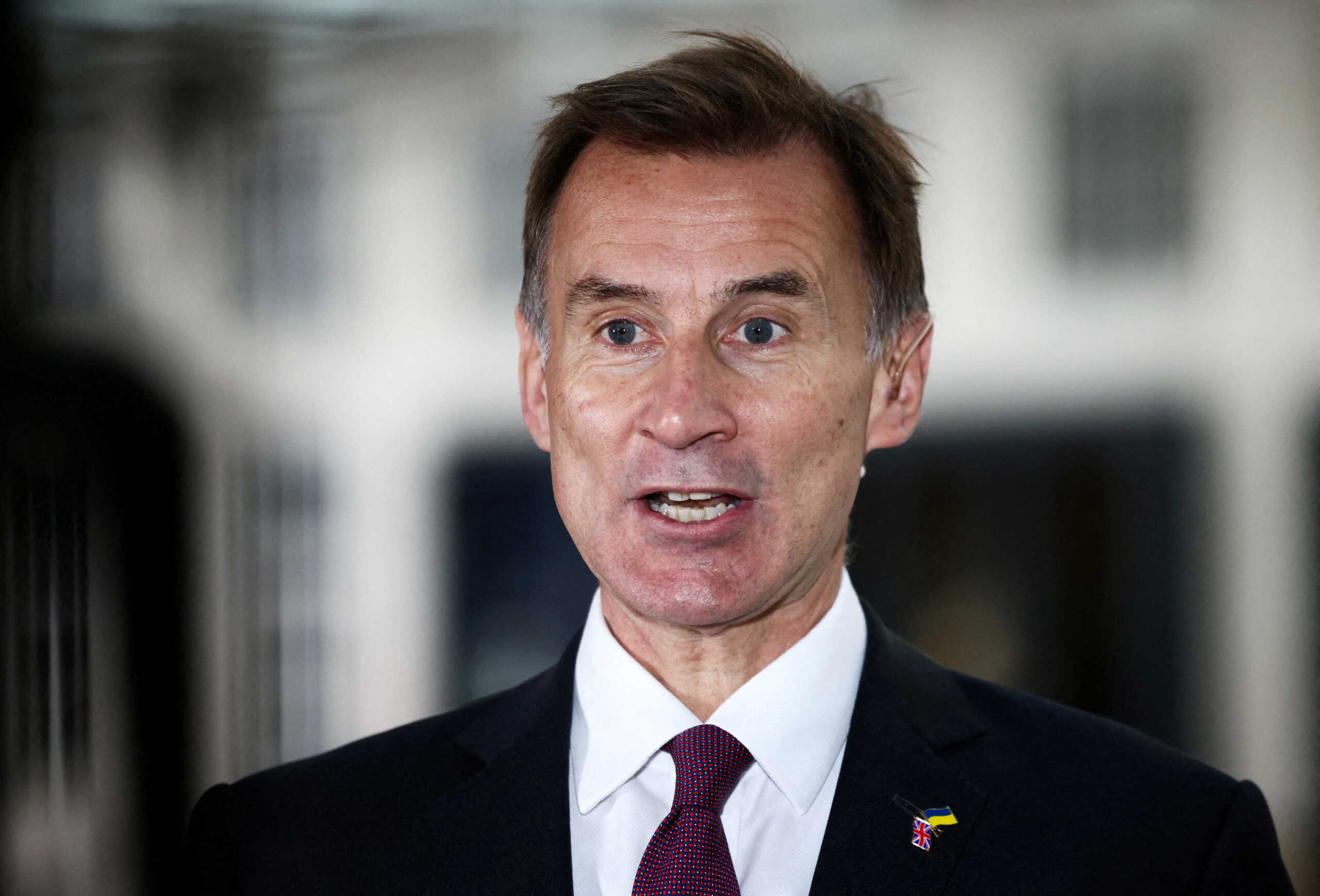 FILE PHOTO: British Chancellor of the Exchequer Jeremy Hunt talks to a television crew outside the BBC headquarters in London, Britain November 18, 2022. REUTERS