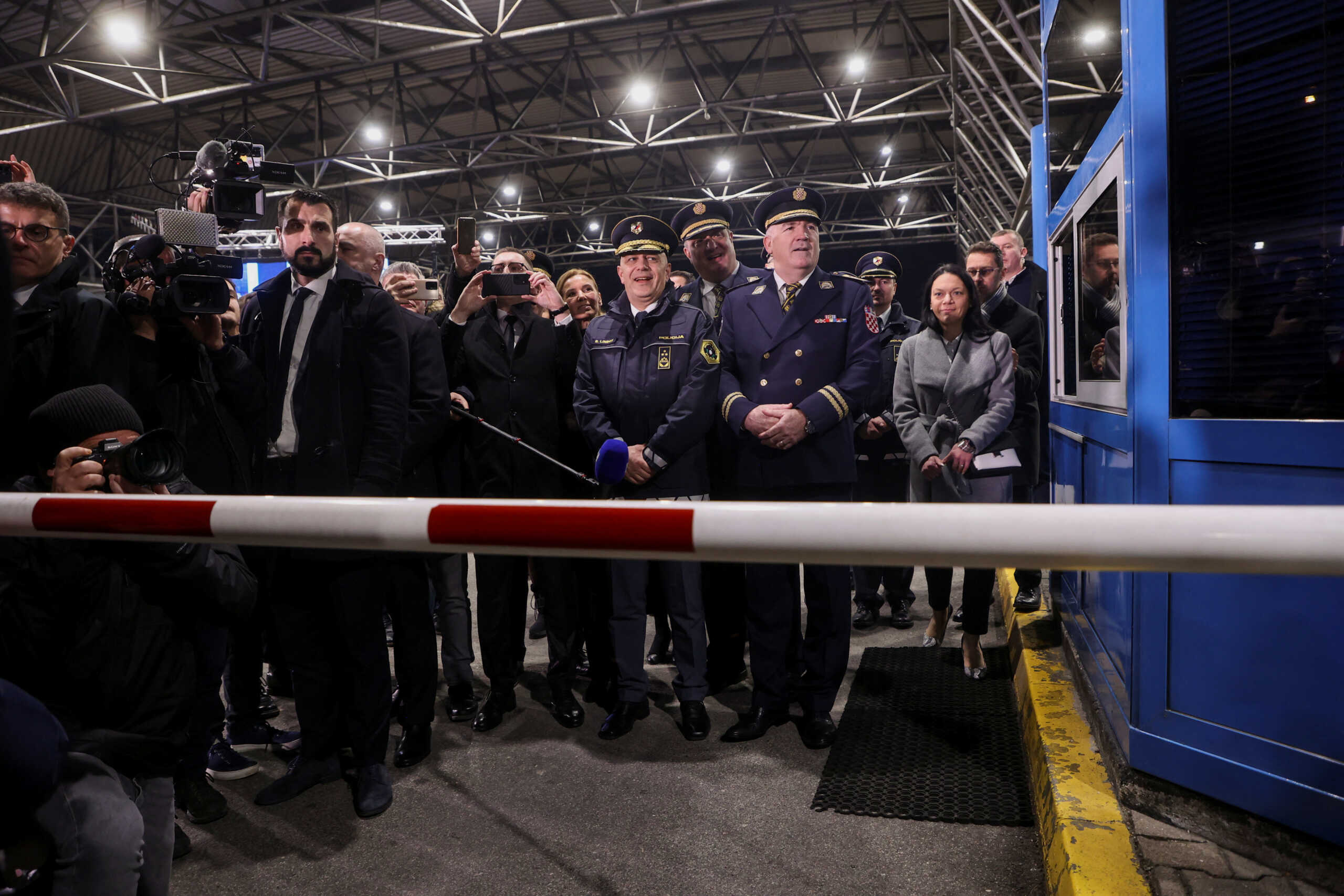 People attend the opening of the border cross as Croatia enters the EU's control-free Schengen Area, in Bregana, Croatia, January 1, 2023. REUTERS