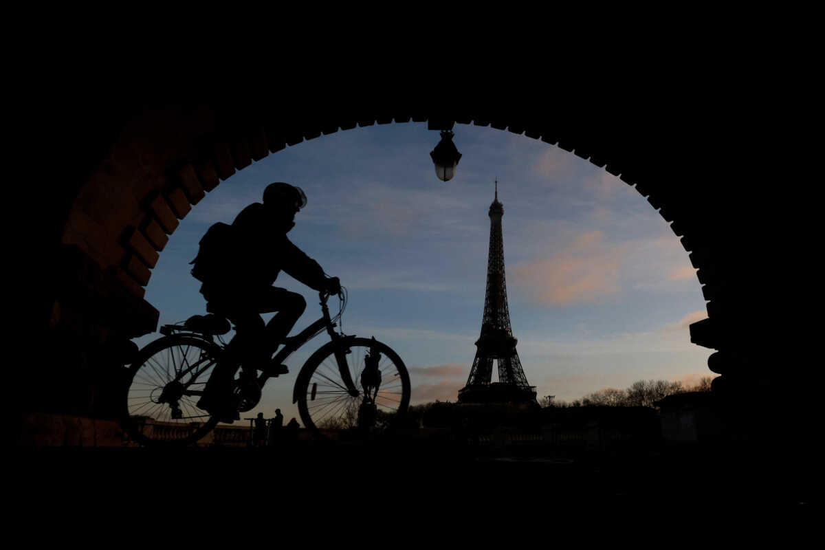 A man rides a bicycle along a bike path on the Pont de Bir-Hakeim bridge near the Eiffel Tower in Paris during a nationwide day of strike and protests against the French government's pension reform plan in France, January 19, 2023. REUTERS