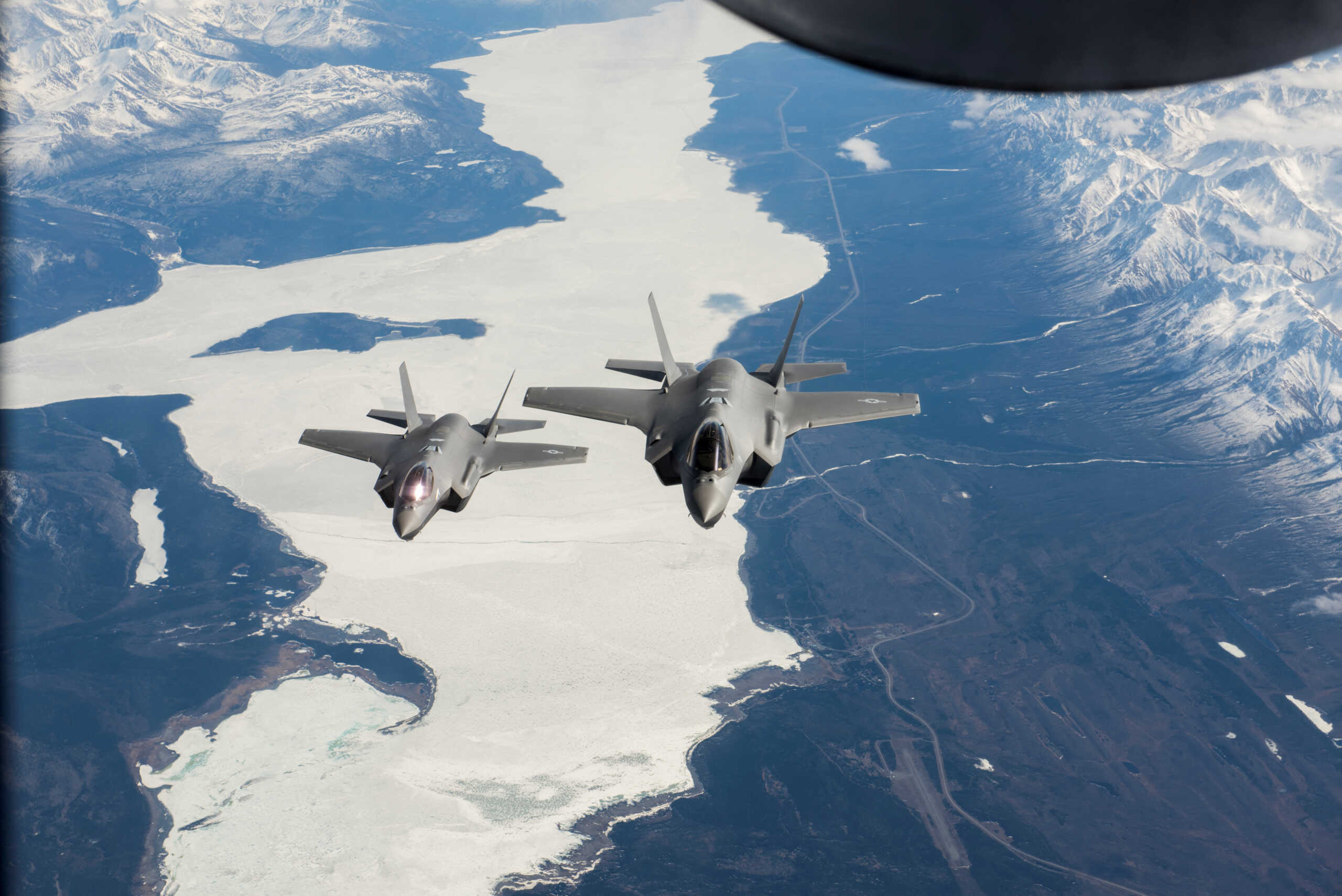 Two U.S. Air Force F-35A Lightning II fighter aircraft fly over the Alaska-Canada Highway en route to their new home at the 354th Fighter Wing, Eielson Air Force Base, Alaska, April 21, 2020.  U.S. Air National Guard