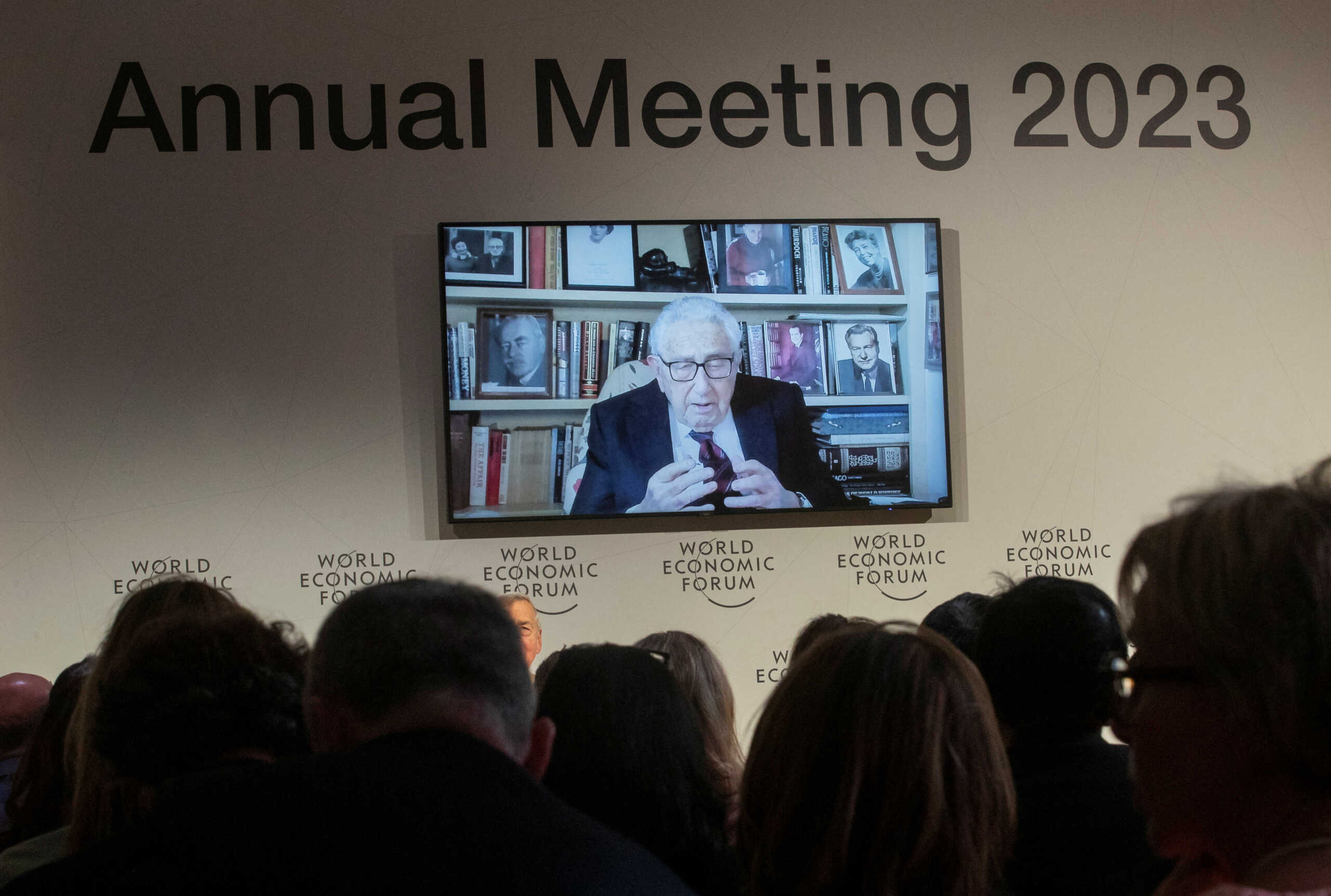 Former U.S. diplomat Henry Kissinger appears on a screen as he delivers a video address to the participants of the World Economic Forum (WEF) 2023, in the Alpine resort of Davos, Switzerland, January 17, 2023. REUTERS