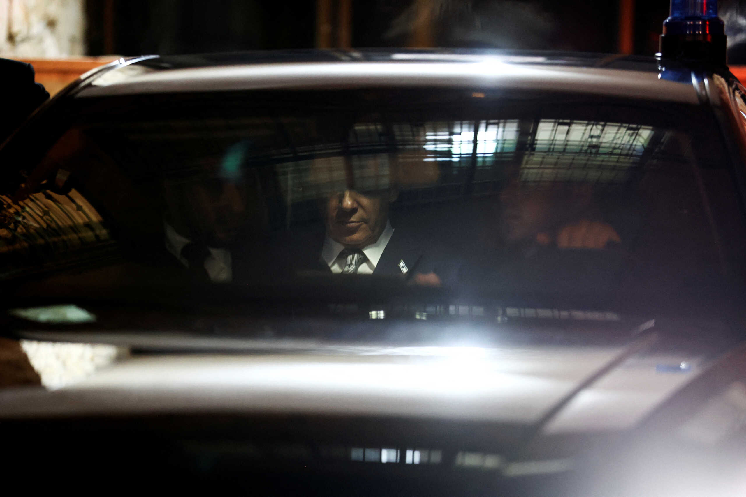 Israeli Prime Minister Benjamin Netanyahu sits in his car after he visited Interior and Health Minister's Aryeh Deri home in Jerusalem, January 18, 2023. REUTERS