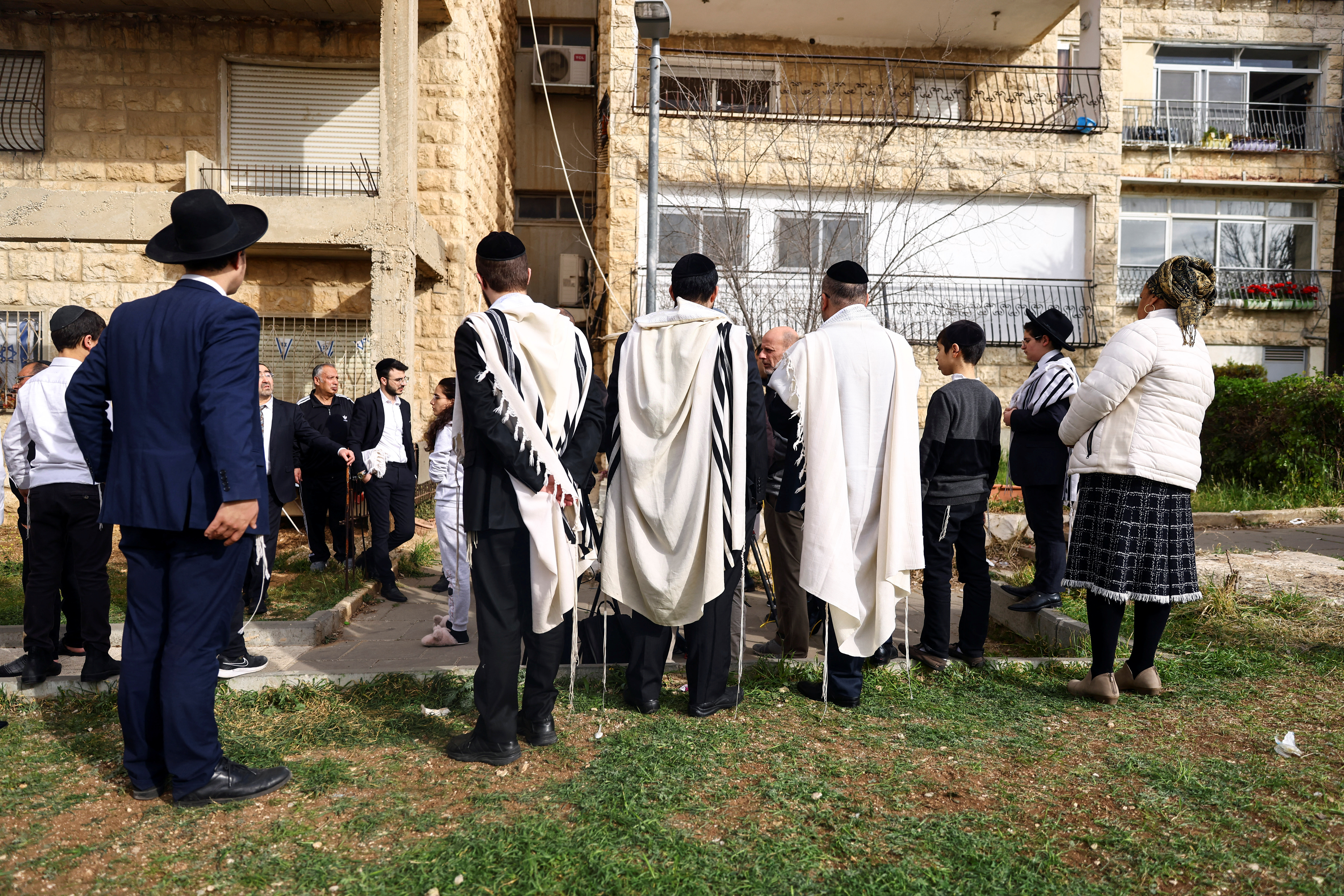 Israelis gather near the scene of a shooting attack that happened the night before, in Neve Yaacov which lies on occupied land that Israel annexed to Jerusalem after the 1967 Middle East war, January 28, 2023. REUTERS