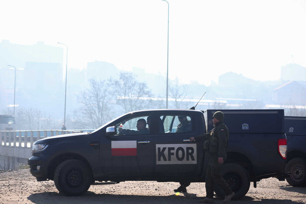 Members of the Polish Armed Forces, part of NATO peacekeepers mission in Kosovo, get into a vehicle, near a roadblock in Rudare, near the northern part of the ethnically-divided town of Mitrovica, Kosovo, December 27, 2022. REUTERS