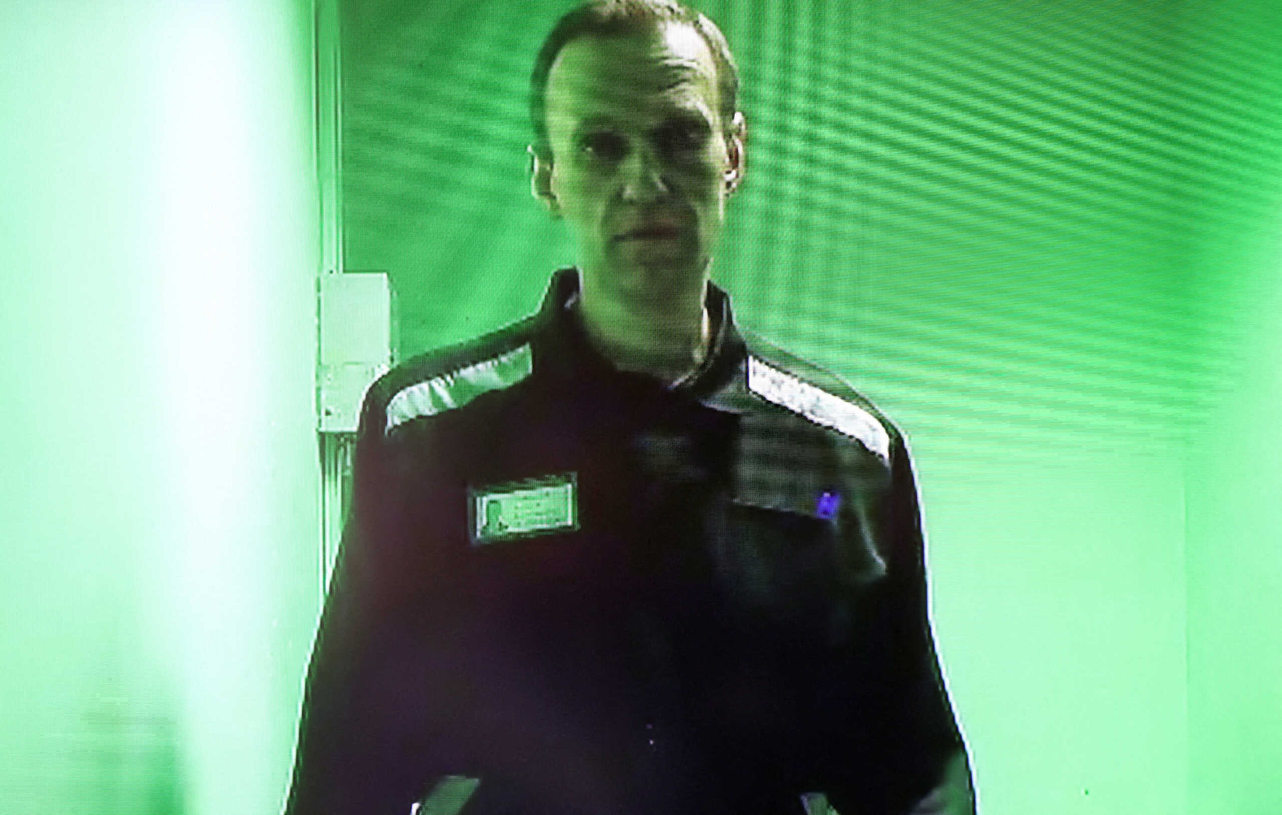 FILE PHOTO: Russian opposition politician Alexei Navalny is seen on a screen via a video link during a court hearing to consider his claims against the administration of a penal colony, where he serves a sentence after being found guilty of parole violations, fraud and contempt of court charges, in the town of Kovrov, Russia October 7, 2022. REUTERS