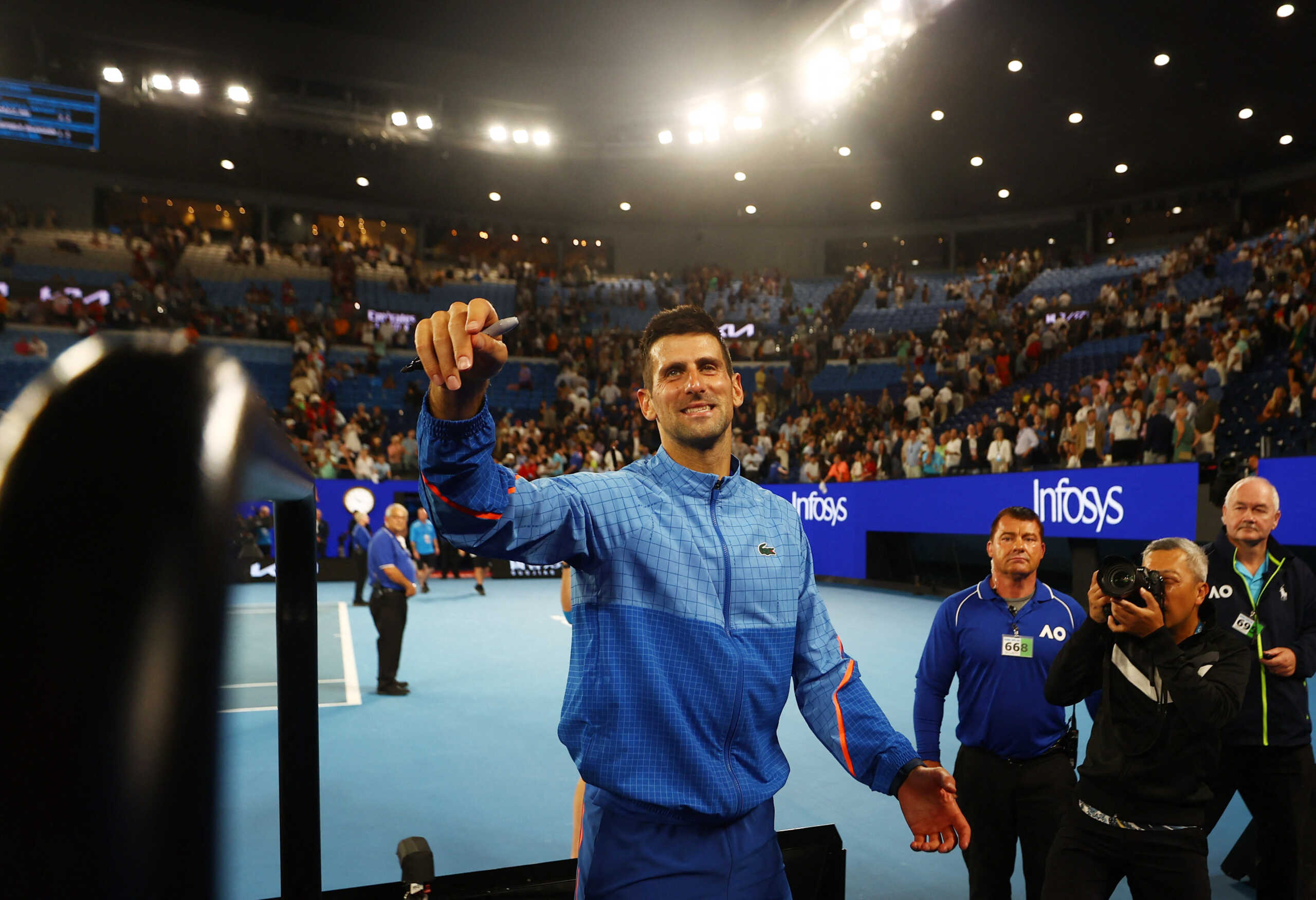 Tennis - Australian Open - Melbourne Park, Melbourne, Australia - January 27, 2023 Serbia’s Novak Djokovic signs autographs for fans after winning his semi final match against Tommy Paul of the U.S. REUTERS