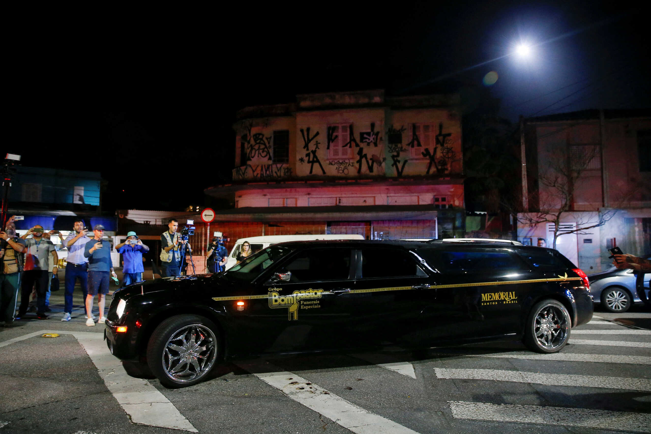 A vehicle transports the body of Brazilian soccer legend Pele, near the Vila Belmiro stadium in Santos, Brazil, January 2, 2023. REUTERS