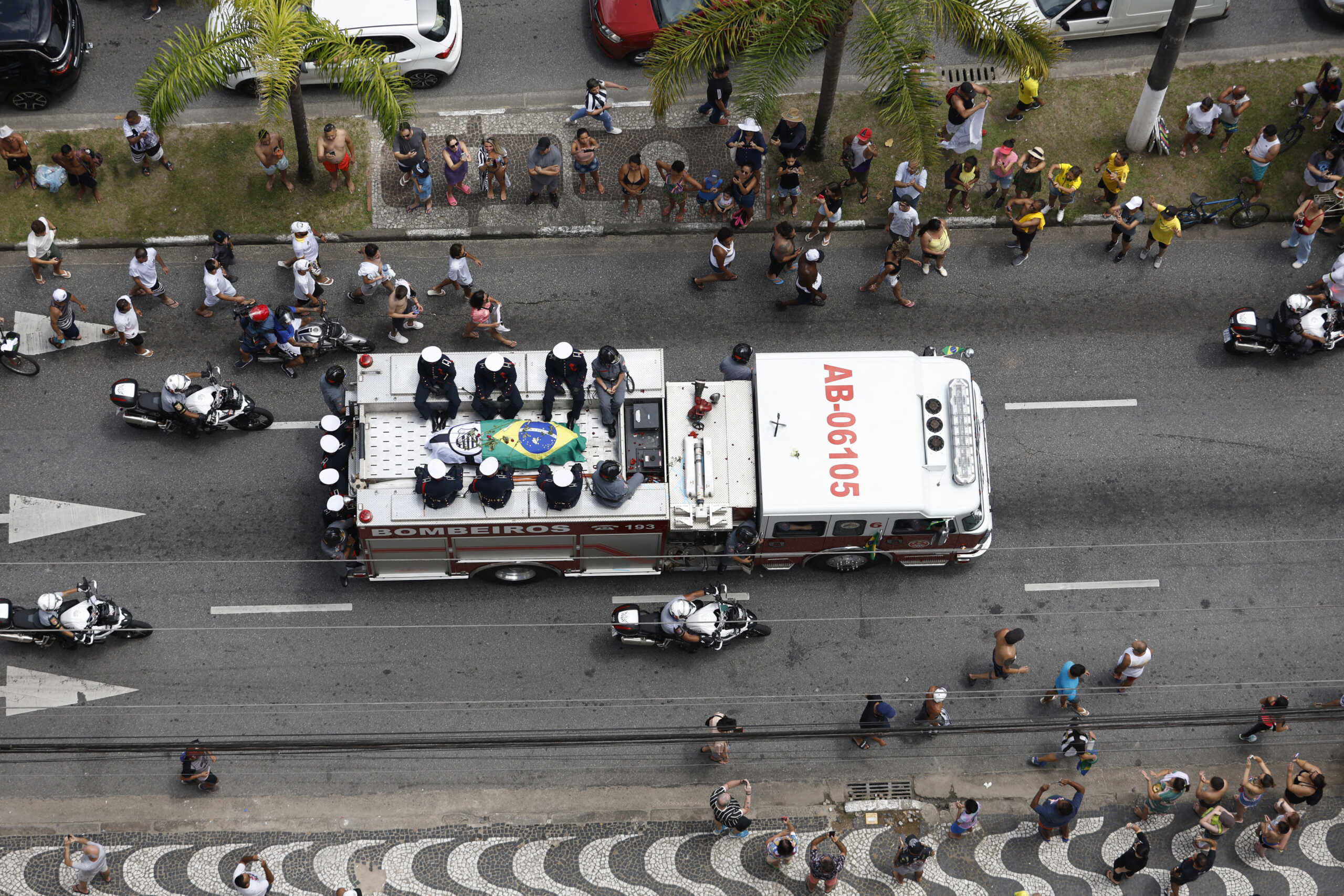 Soccer Football - Death of Brazilian soccer legend Pele - Santos, Brazil - January 3, 2023 General view of fans as the casket of Brazilian soccer legend Pele is transported by the fire department, from his former club Santos' Vila Belmiro stadium REUTERS
