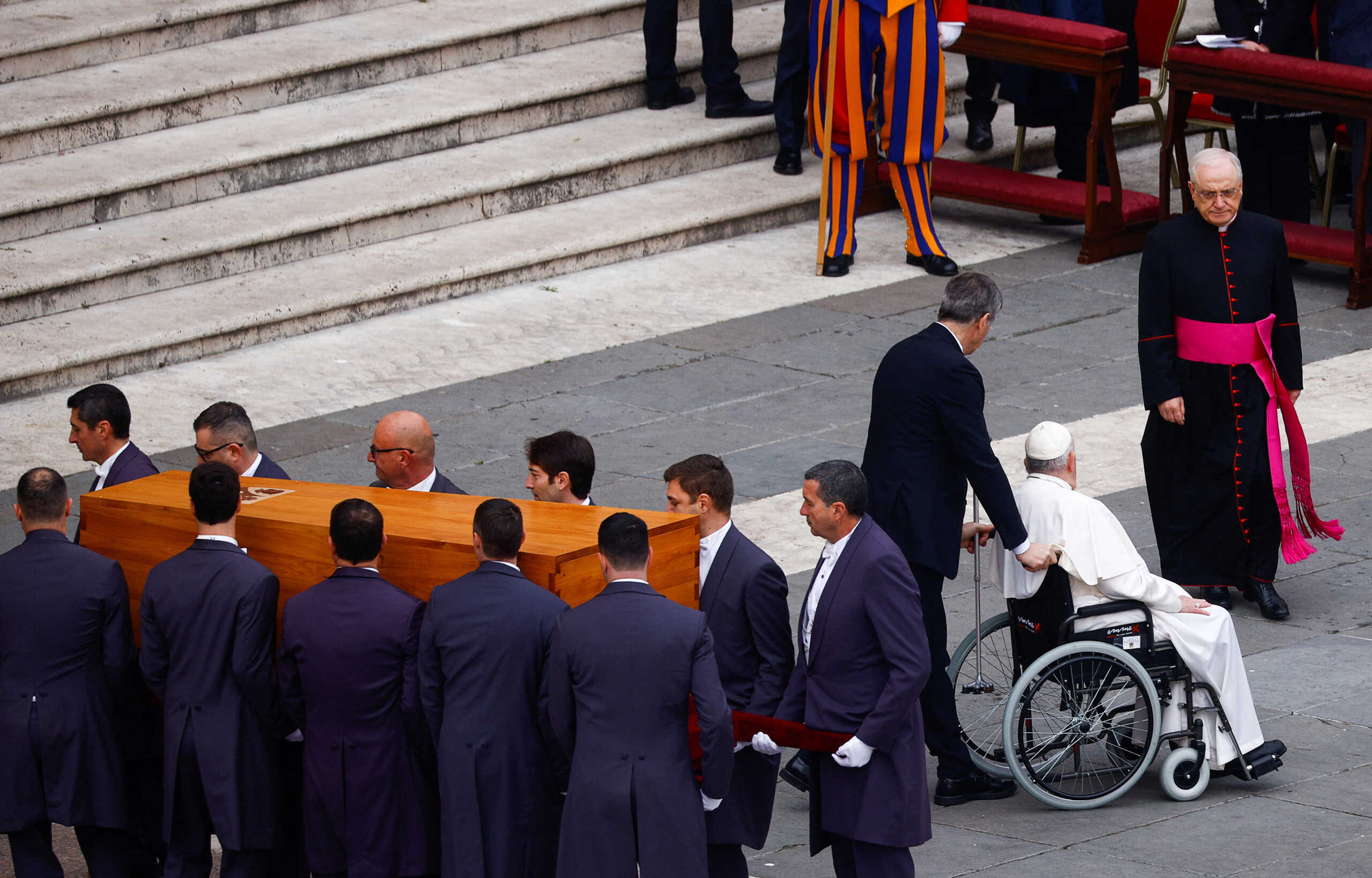 Pope Francis sits, as pallbearers carry the coffin of former Pope Benedict during his funeral, in St. Peter's Square at the Vatican, January 5, 2023. REUTERS