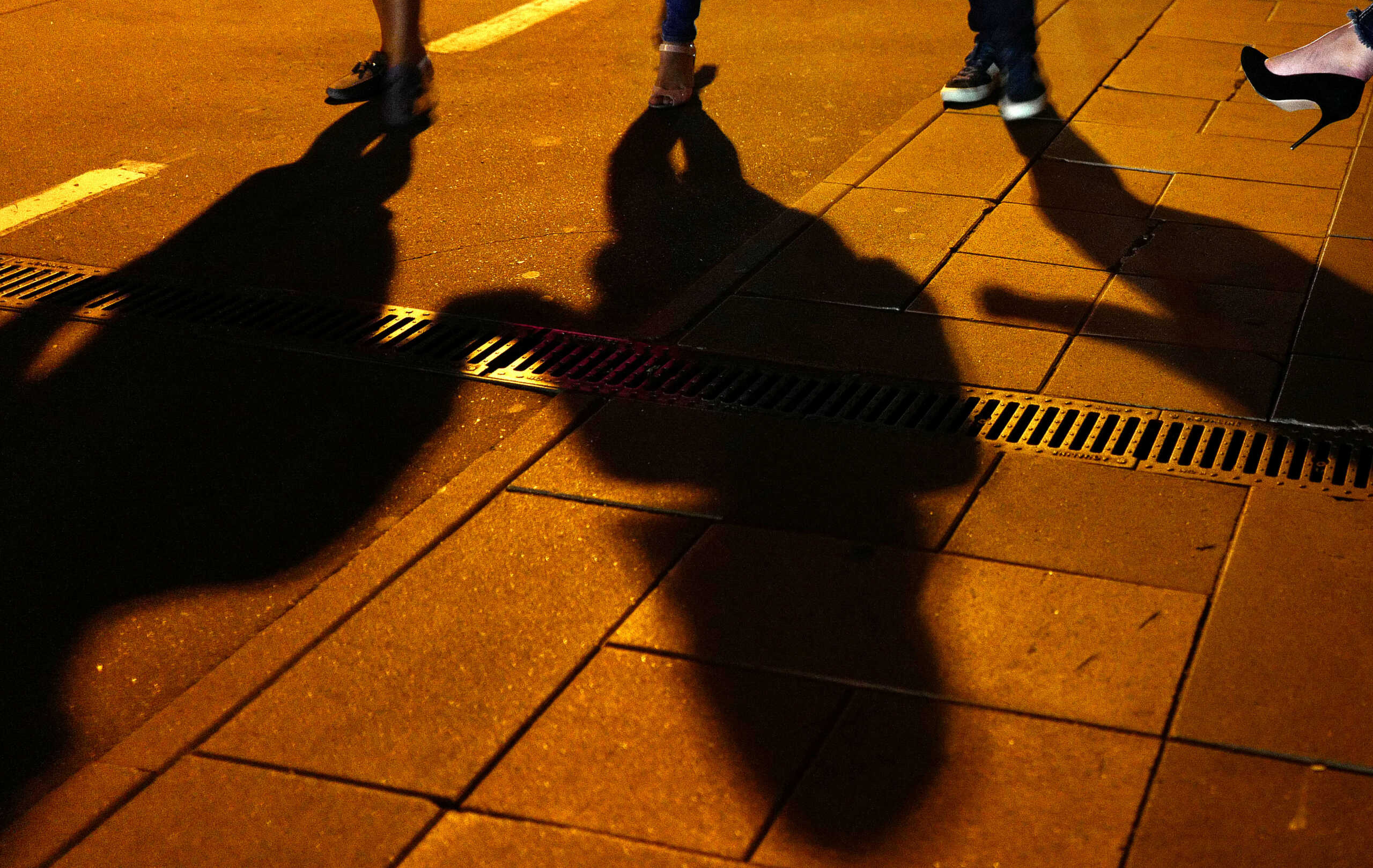 People cast their shadows outside a bar in Moscow, Russia July 13, 2018. Picture taken July 13, 2018.  REUTERS