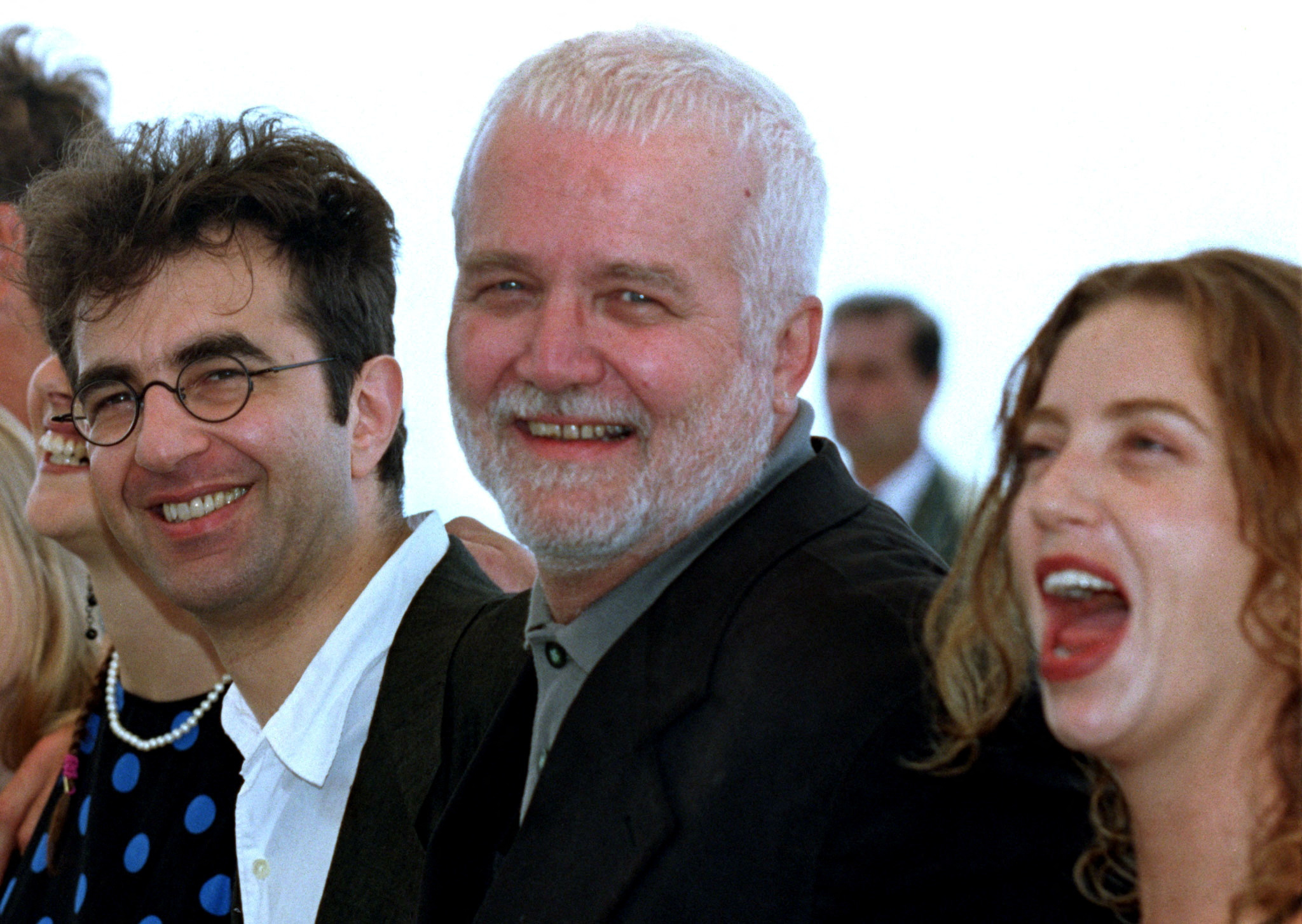 FILE PHOTO: American author Russell Banks stands between his daughter, actor Caerthan Banks, and Canadian director Atom Egoyan during a photo call for their film "The Sweet Hereafter" at the 50th Cannes Film Festival, in Cannes, France, May 15, 1997. REUTERS