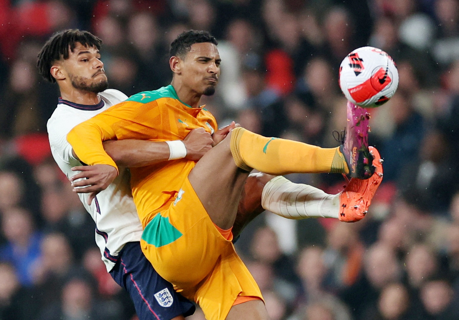 FILE PHOTO: Soccer Football - International Friendly - England v Ivory Coast - Wembley Stadium, London, Britain - March 29, 2022  Ivory Coast's Sebastien Haller in action with England's Tyrone Mings Action Images via Reuters