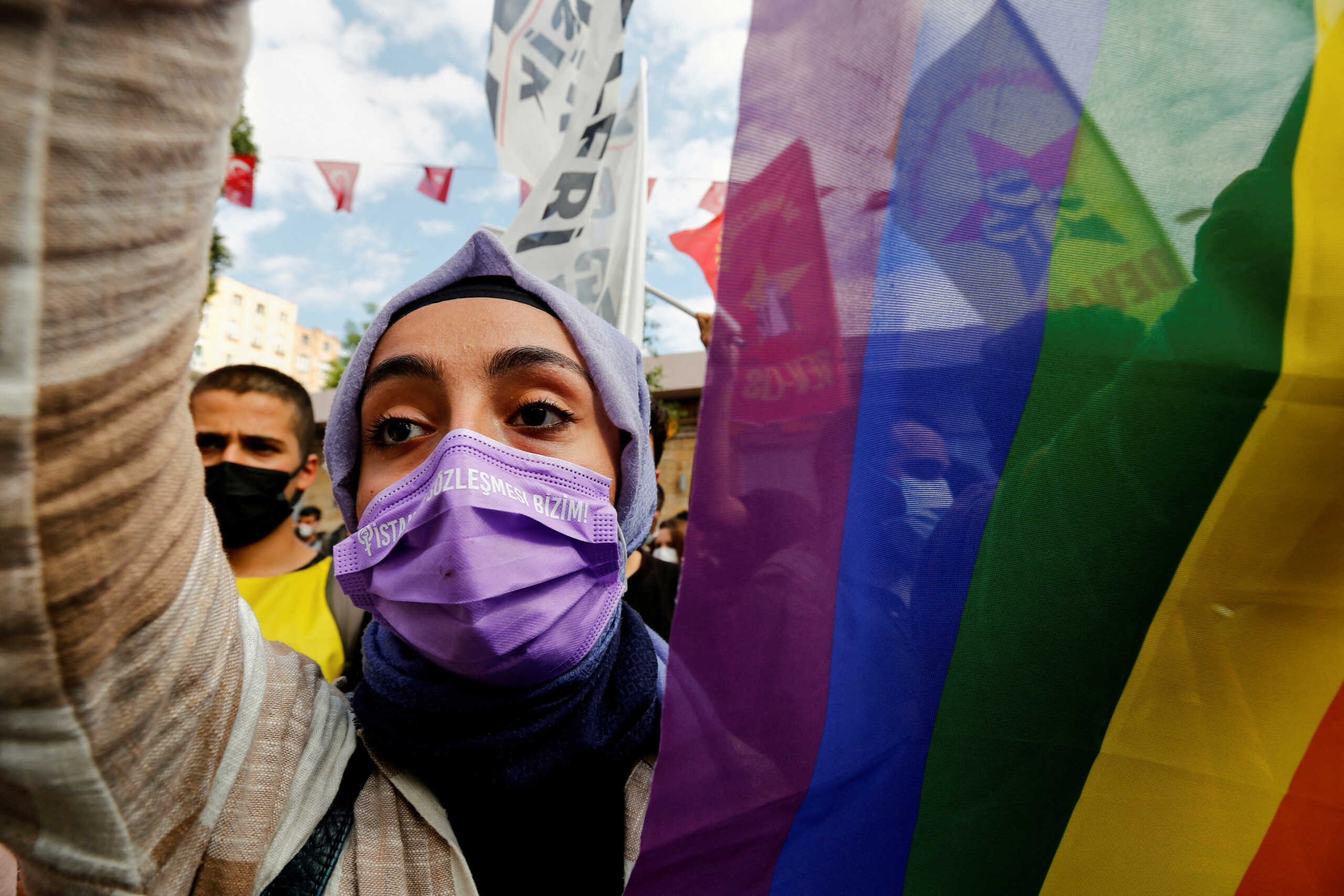 FILE PHOTO: A demonstrator carries a rainbow flag during a protest against an attack on a local office of the pro-Kurdish Peoples' Democratic Party (HDP) and the killing of a woman working in the office, in Istanbul, Turkey June 17, 2021. REUTERS