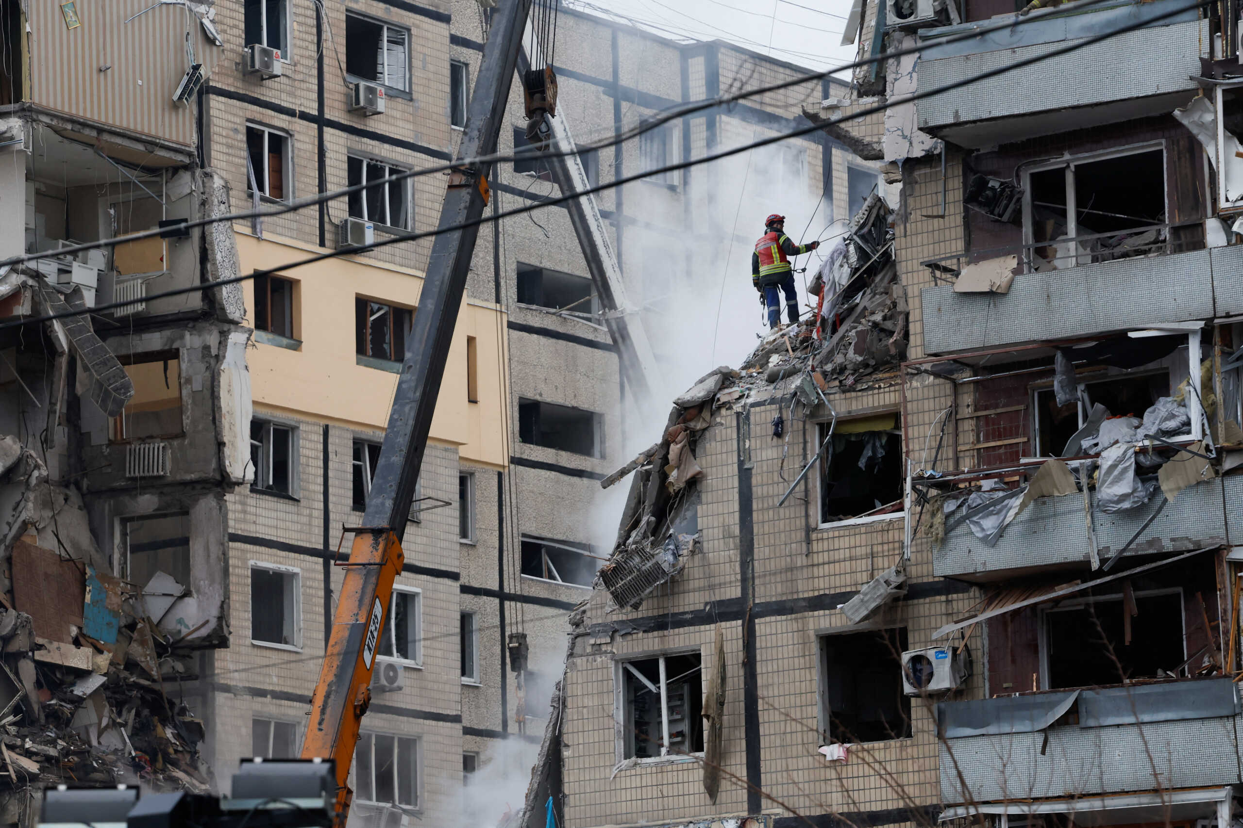 An emergency personnel works at the site where an apartment block was heavily damaged by a Russian missile strike, amid Russia's attack on Ukraine, in Dnipro, Ukraine January 15, 2023. REUTERS