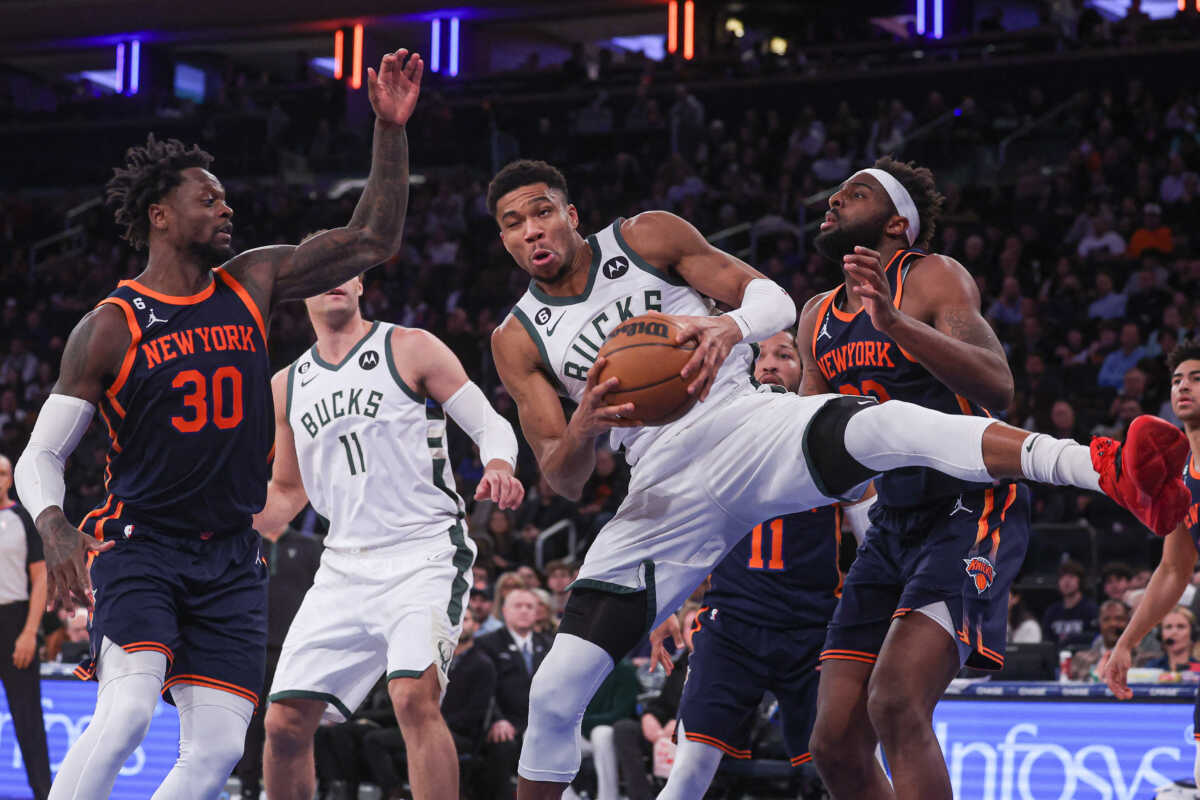 Jan 9, 2023; New York, New York, USA; Milwaukee Bucks forward Giannis Antetokounmpo (34) rebounds in front of New York Knicks center Mitchell Robinson (23) and forward Julius Randle (30) during the during the third quarter  at Madison Square Garden. Mandatory Credit: Vincent Carchietta-USA TODAY Sports