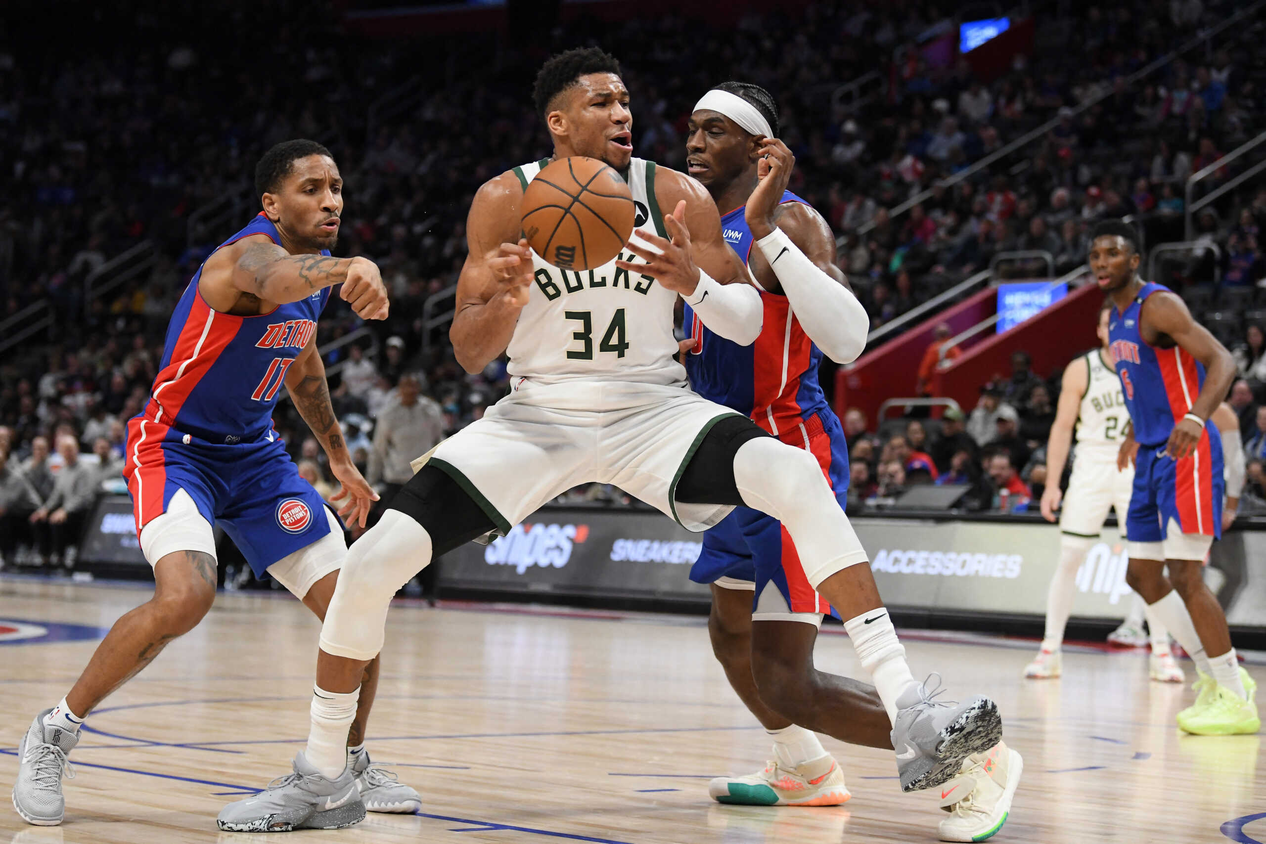 Jan 23, 2023; Detroit, Michigan, USA; Milwaukee Bucks forward Giannis Antetokounmpo's (34) drives to the basket against Detroit Pistons guard Rodney McGruder (17) (left) and center Jalen Duran (0) in the third quarter at Little Caesars Arena. Mandatory Credit: Lon Horwedel-USA TODAY Sports
