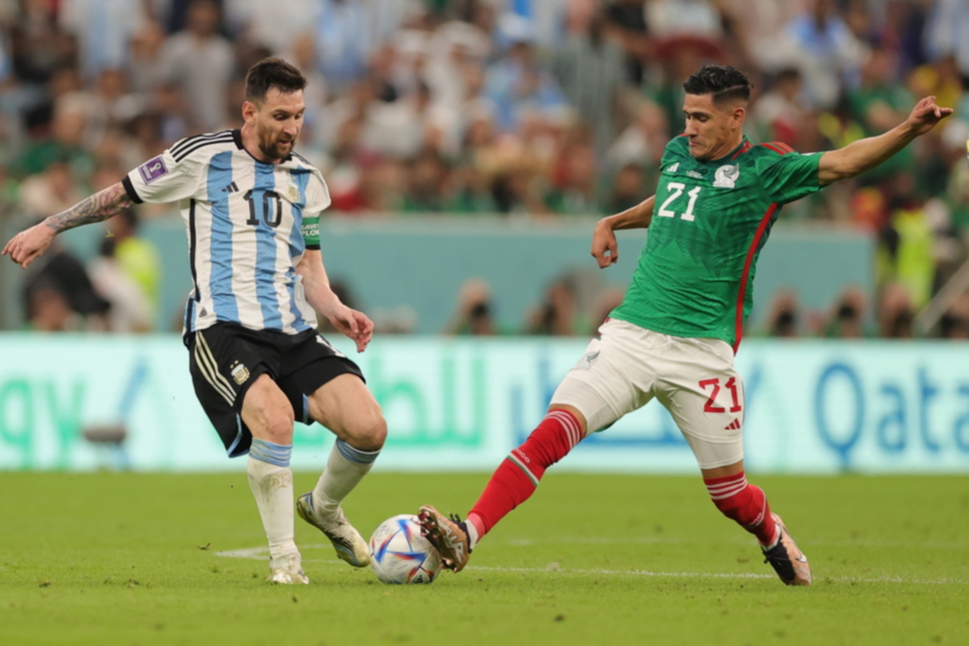epa10331248 Lionel Messi of Argentina in action against Uriel Antuna (R) of Mexico during the FIFA World Cup 2022 group C soccer match between Argentina and Mexico at Lusail Stadium in Lusail, Qatar, 26 November 2022.  EPA