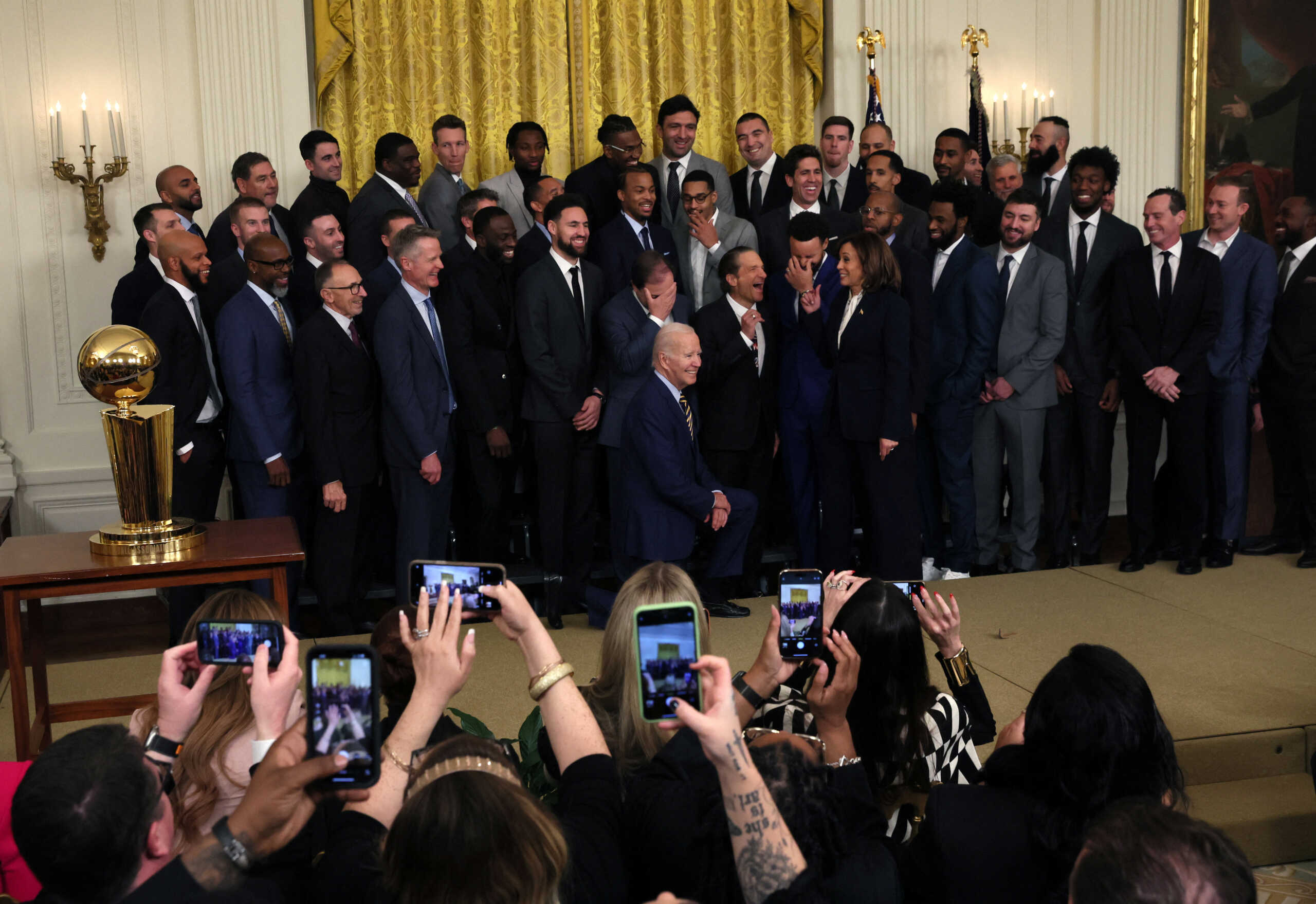 U.S. President Joe Biden and Vice President Kamala Harris pose for a group photo during an event in the East Room hosted by President Biden and Vice President Harris to honor the Golden State Warriors for their 2022 NBA championship at the White House in Washington, U.S., January 17, 2023. REUTERS