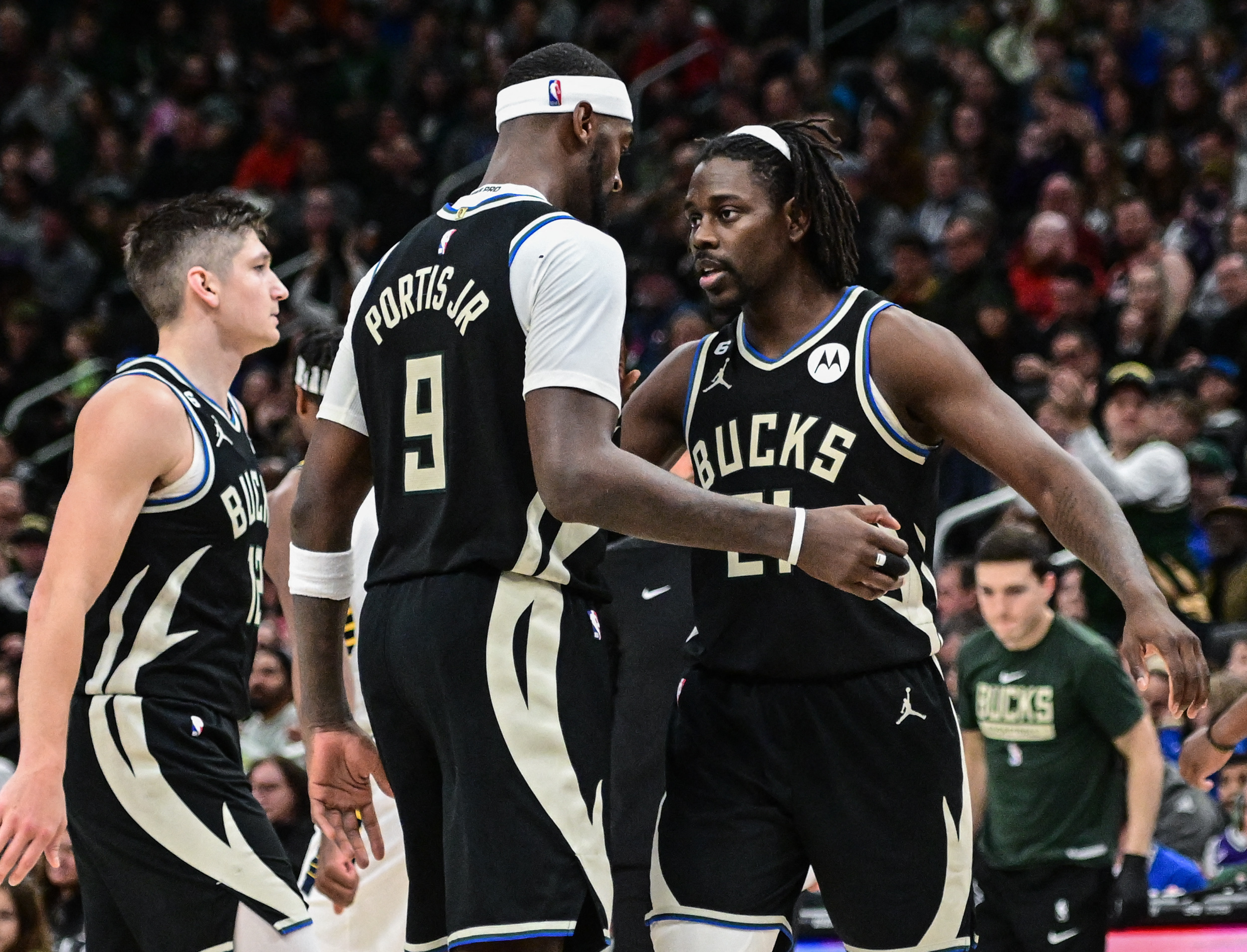 Jan 16, 2023; Milwaukee, Wisconsin, USA; Milwaukee Bucks guard Jrue Holiday (21) reacts with forward Bobby Portis (9) after scoring a basket in the fourth quarter during game against the Indiana Pacers at Fiserv Forum. Mandatory Credit: Benny Sieu-USA TODAY Sports