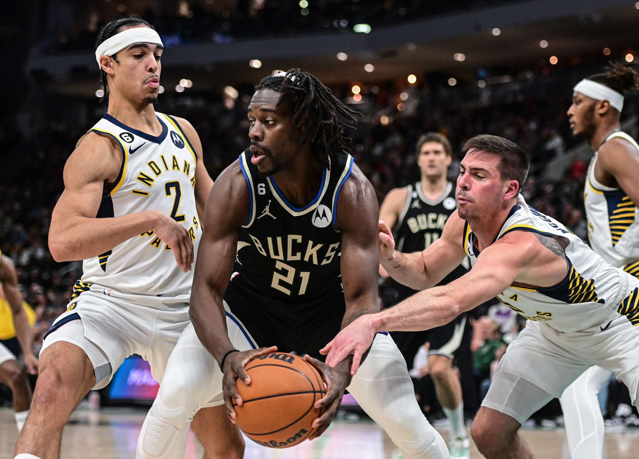 Jan 16, 2023; Milwaukee, Wisconsin, USA; Indiana Pacers guard T.J. McConnell (9) tries to steal the ball from Milwaukee Bucks guard Jrue Holiday (21) in the second quarter at Fiserv Forum. Mandatory Credit: Benny Sieu-USA TODAY Sports
