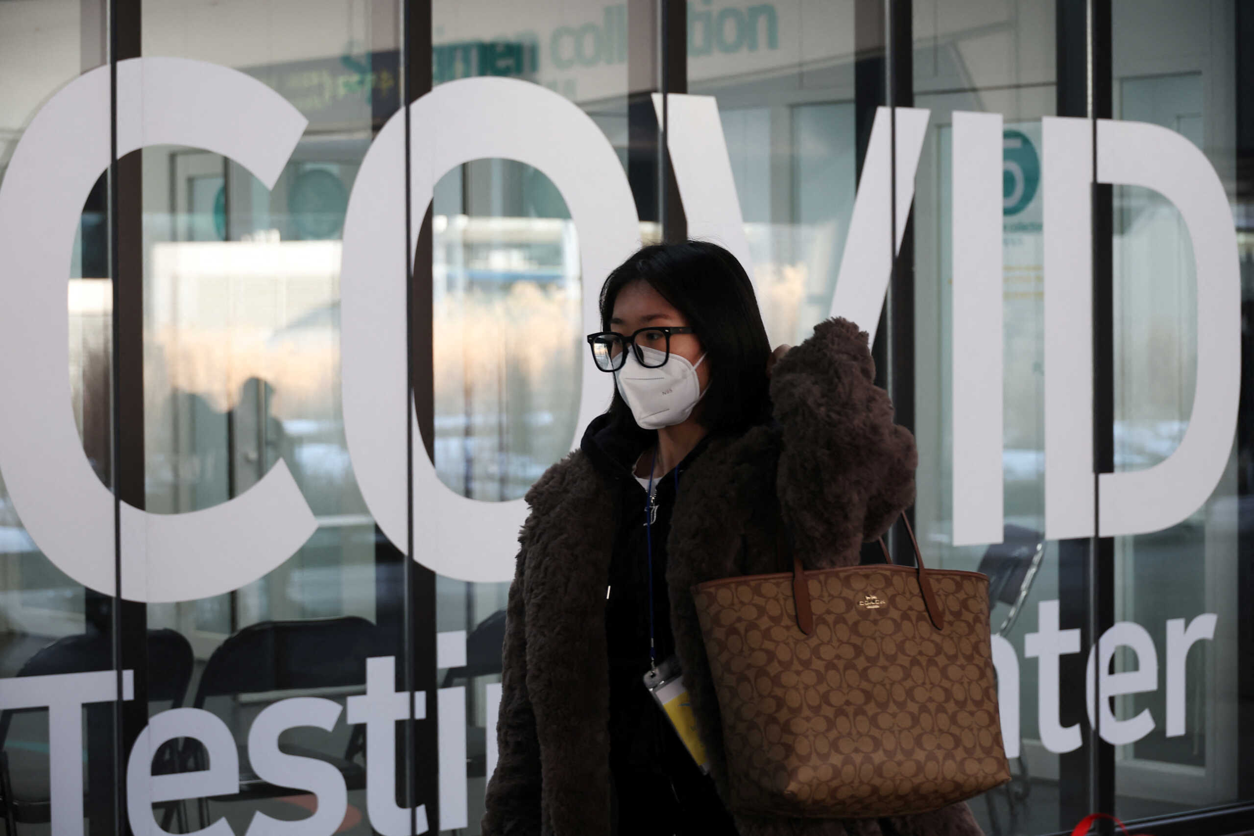 A Chinese tourist walks into coronavirus disease (COVID-19) testing centre upon her arrival at the Incheon International Airport in Incheon, South Korea, January 4, 2023.   REUTERS