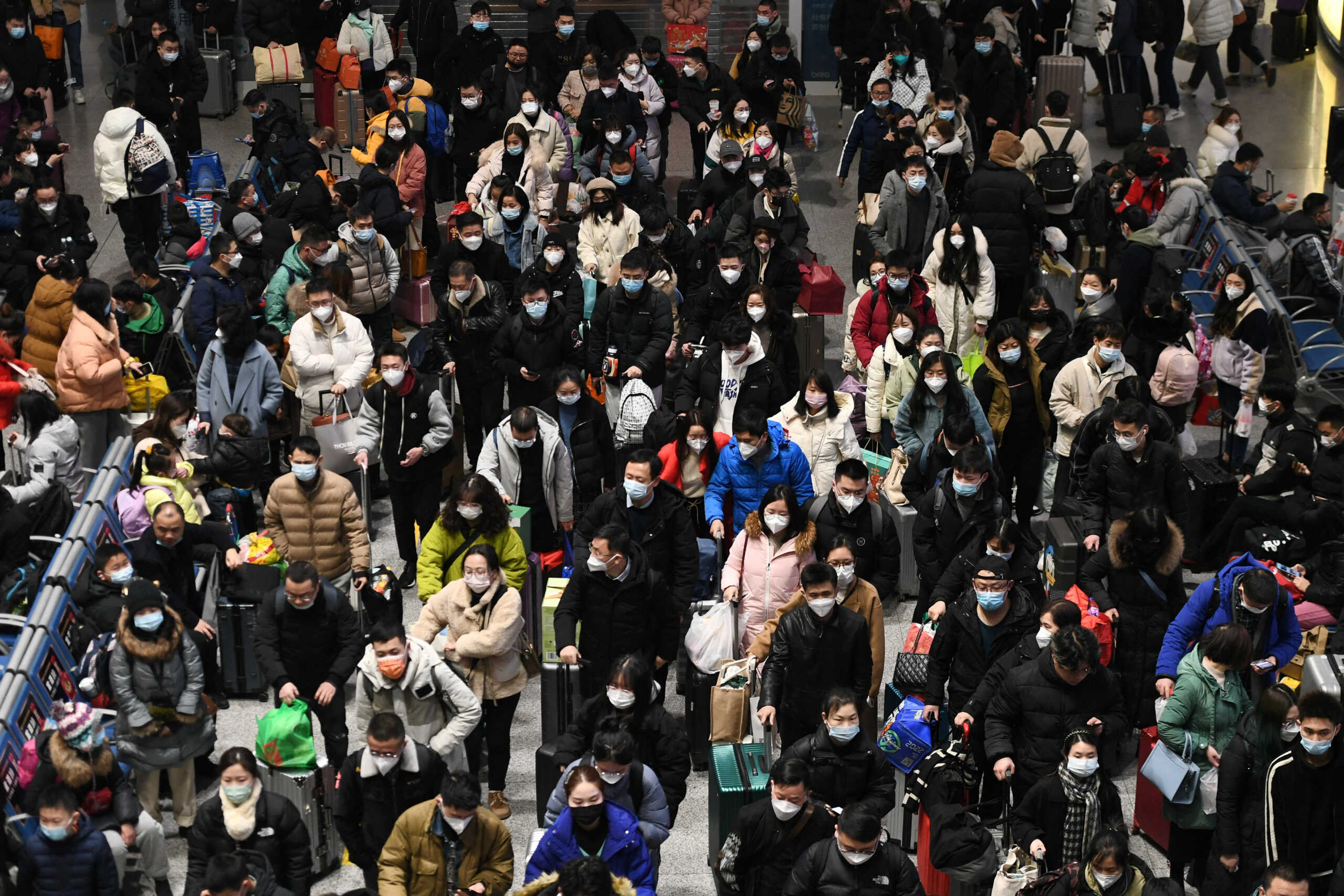 Travellers wait for their trains at Nanjing South railway station during the Spring Festival travel rush ahead of the Chinese Lunar New Year, in Nanjing, Jiangsu province, China January 20, 2023. China Daily via REUTERS  ATTENTION EDITORS - THIS IMAGE WAS PROVIDED BY A THIRD PARTY. CHINA OUT.