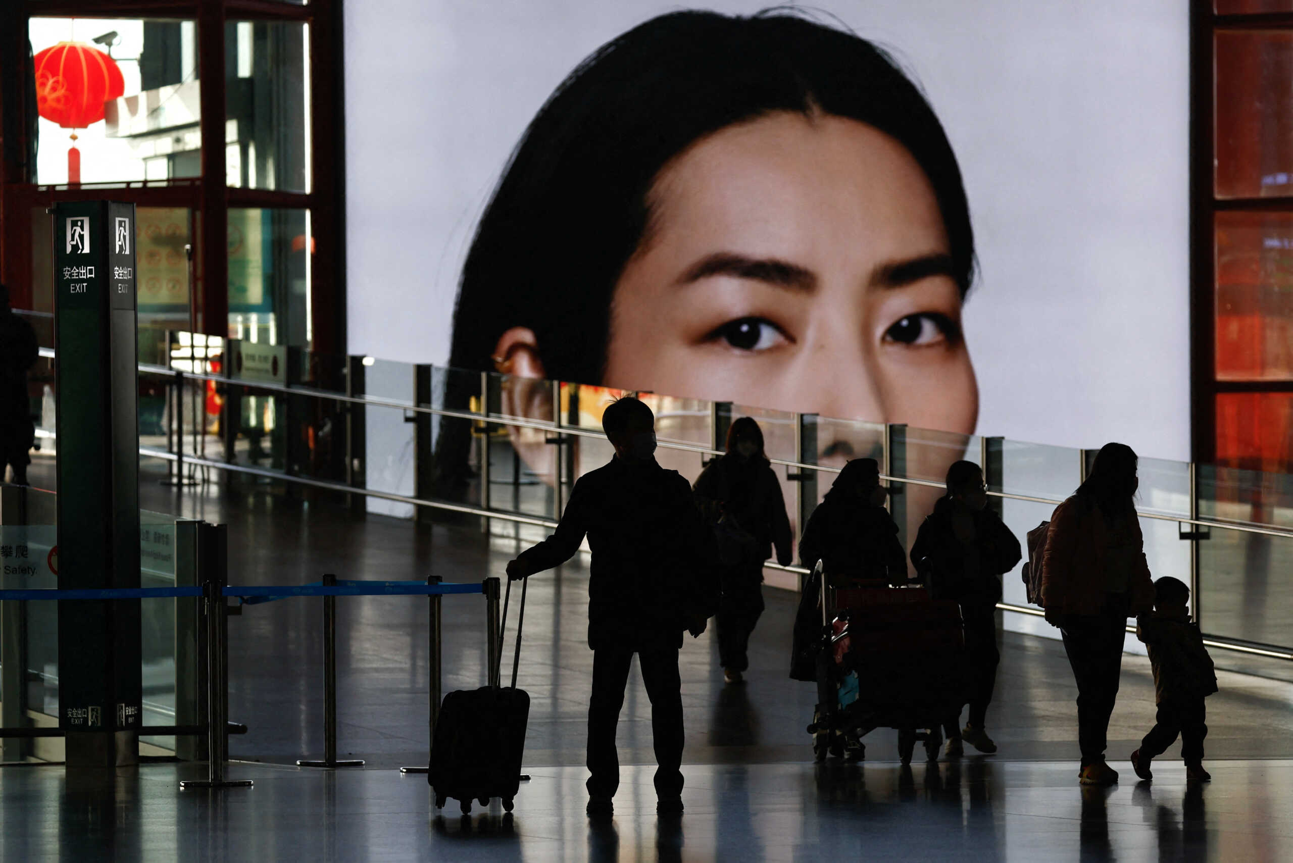 Travellers walk with luggages at a terminal hall, during the annual Spring Festival travel rush ahead of the Chinese Lunar New Year, as the coronavirus disease (COVID-19) outbreak continues, in Beijing Capital International Airport, Beijing, China January 18, 2023. REUTERS