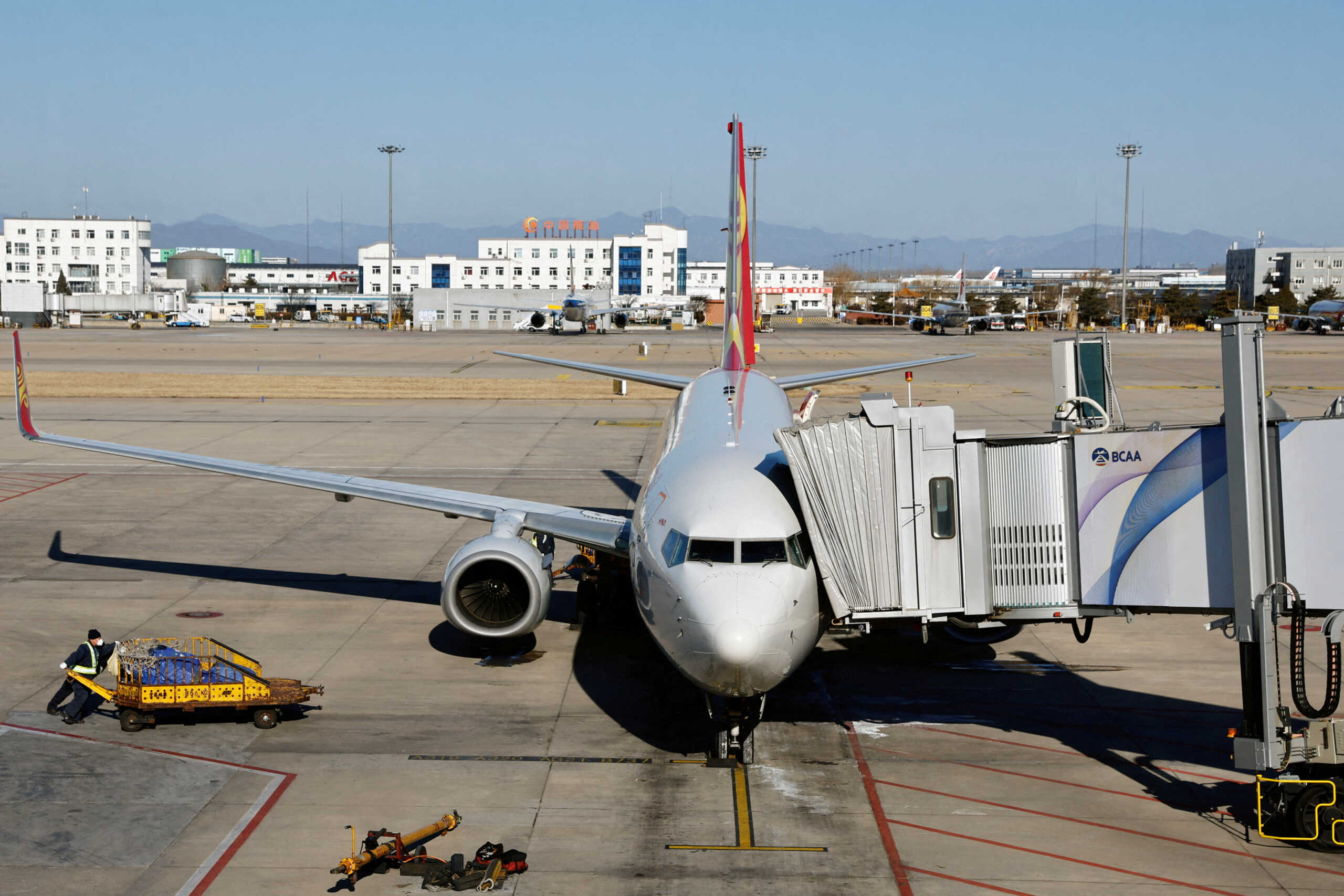 FILE PHOTO: A Hainan Airlines aircraft is seen at Beijing Capital International Airport, amid the coronavirus disease (COVID-19) outbreak in Beijing, China December 27, 2022. REUTERS