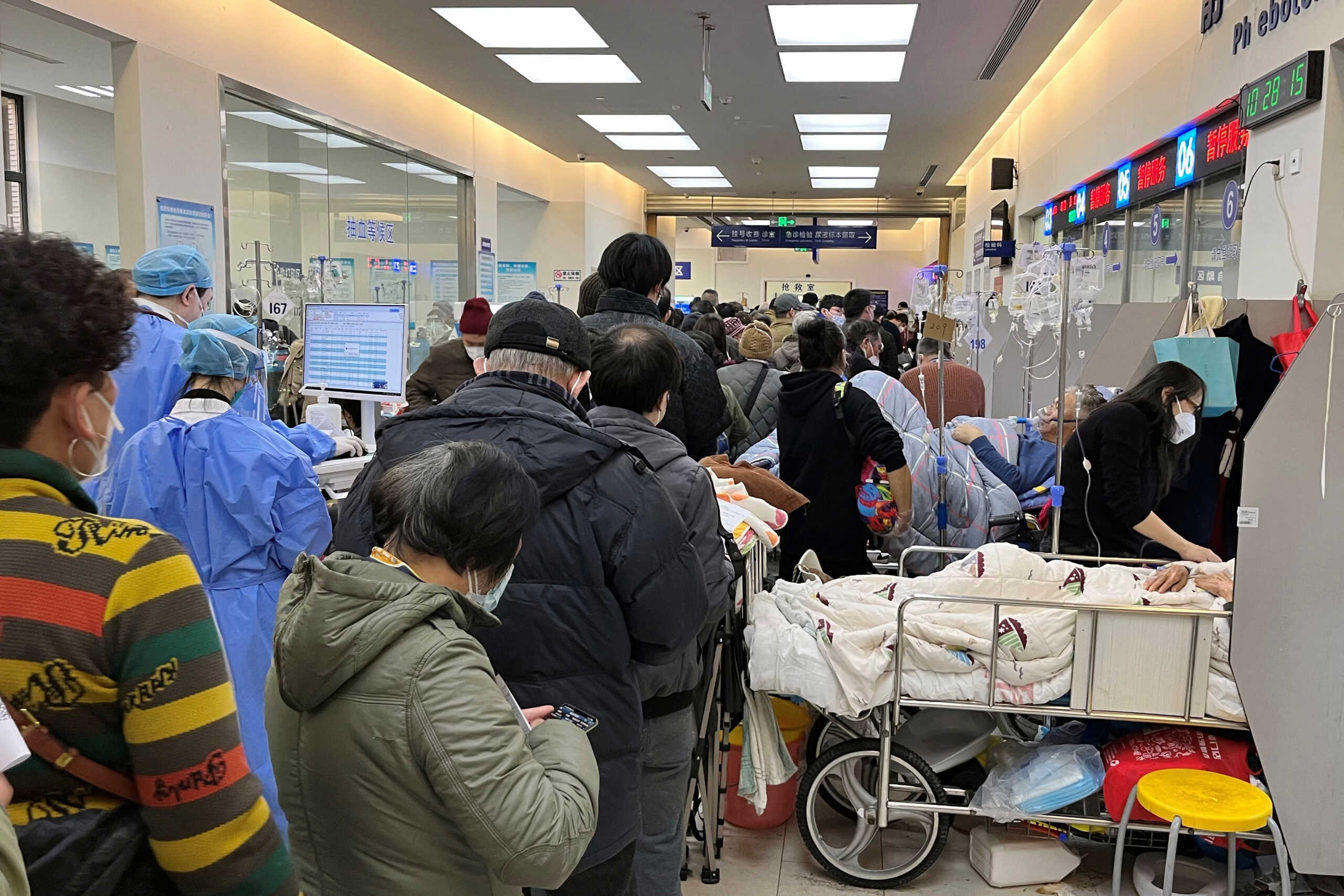 Patients lie on beds next to closed counters at the emergency department of Zhongshan Hospital, amid the coronavirus disease (COVID-19) outbreak in Shanghai, China January 3, 2023. REUTERS
