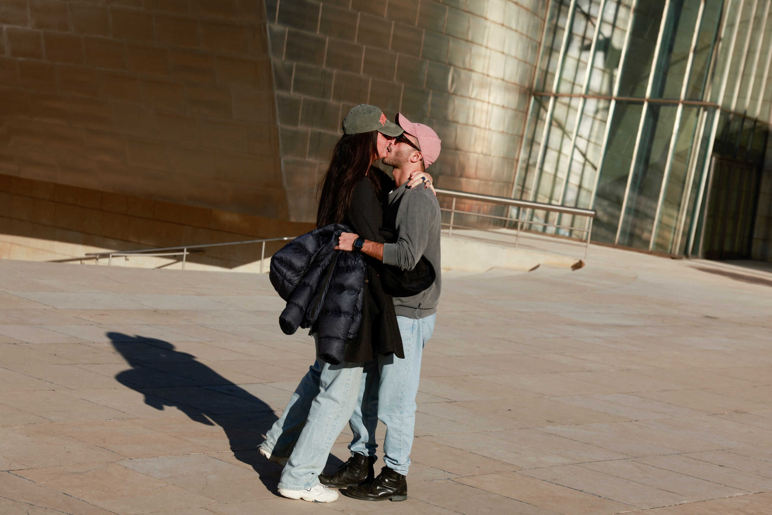 A couple kisses during unseasonably warm temperatures in Bilbao, Spain, January 4, 2023. REUTERS